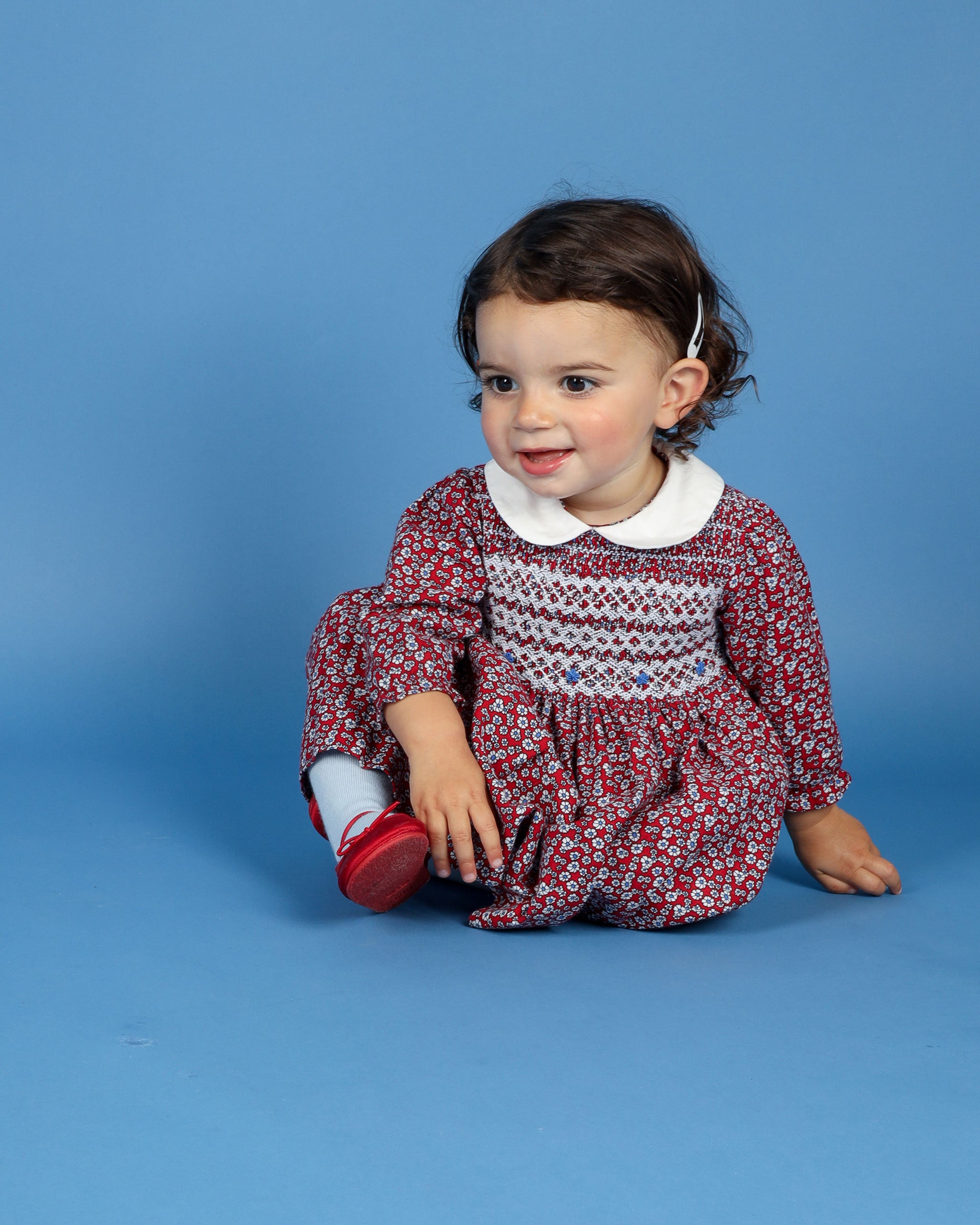 baby in hand smocked floral dress