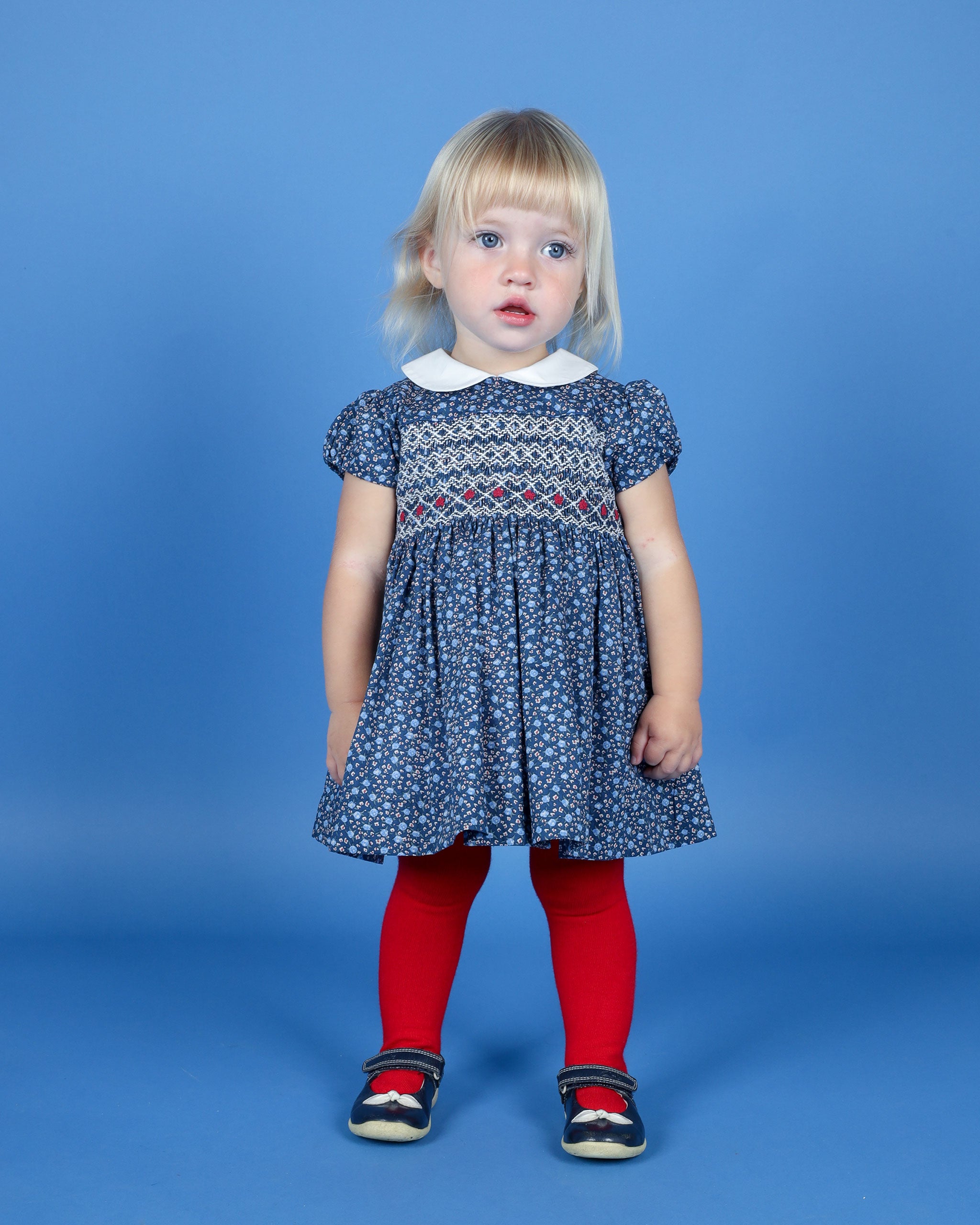 toddler wearing hand-smocked navy dress