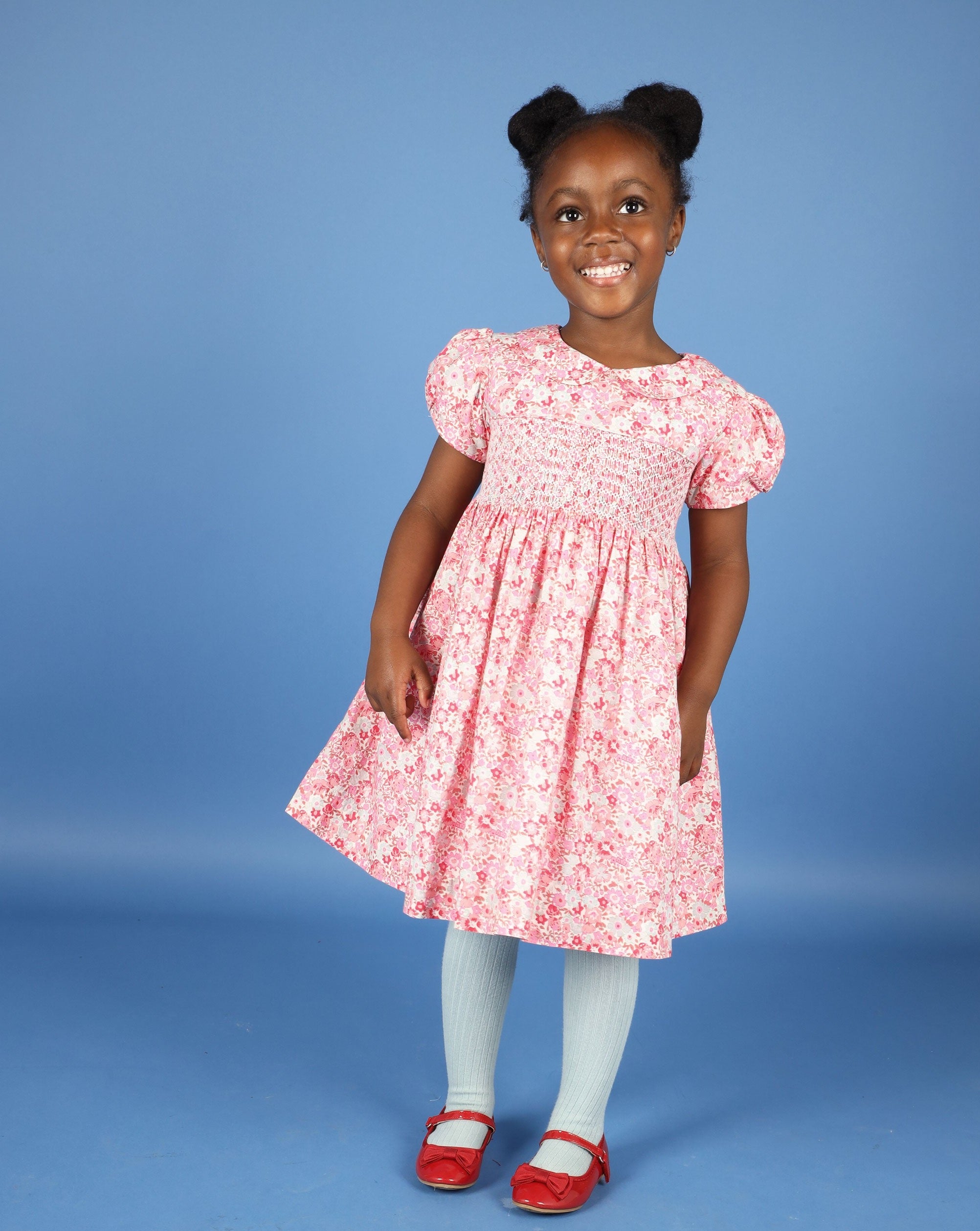 girl in pink smocked summer dress