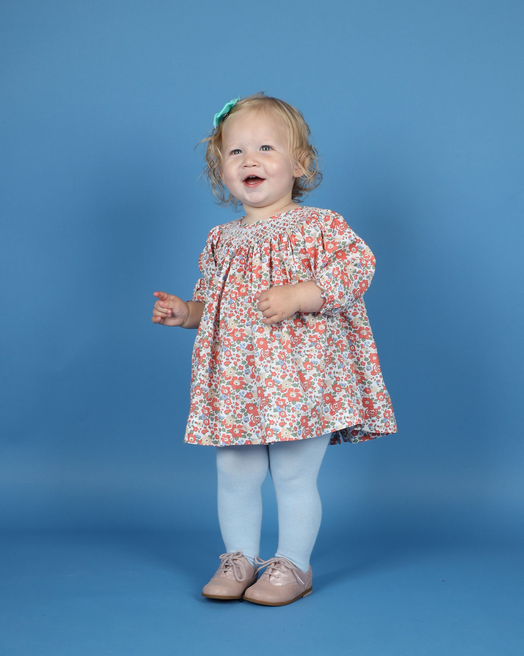 toddler in smocked long sleeve dress