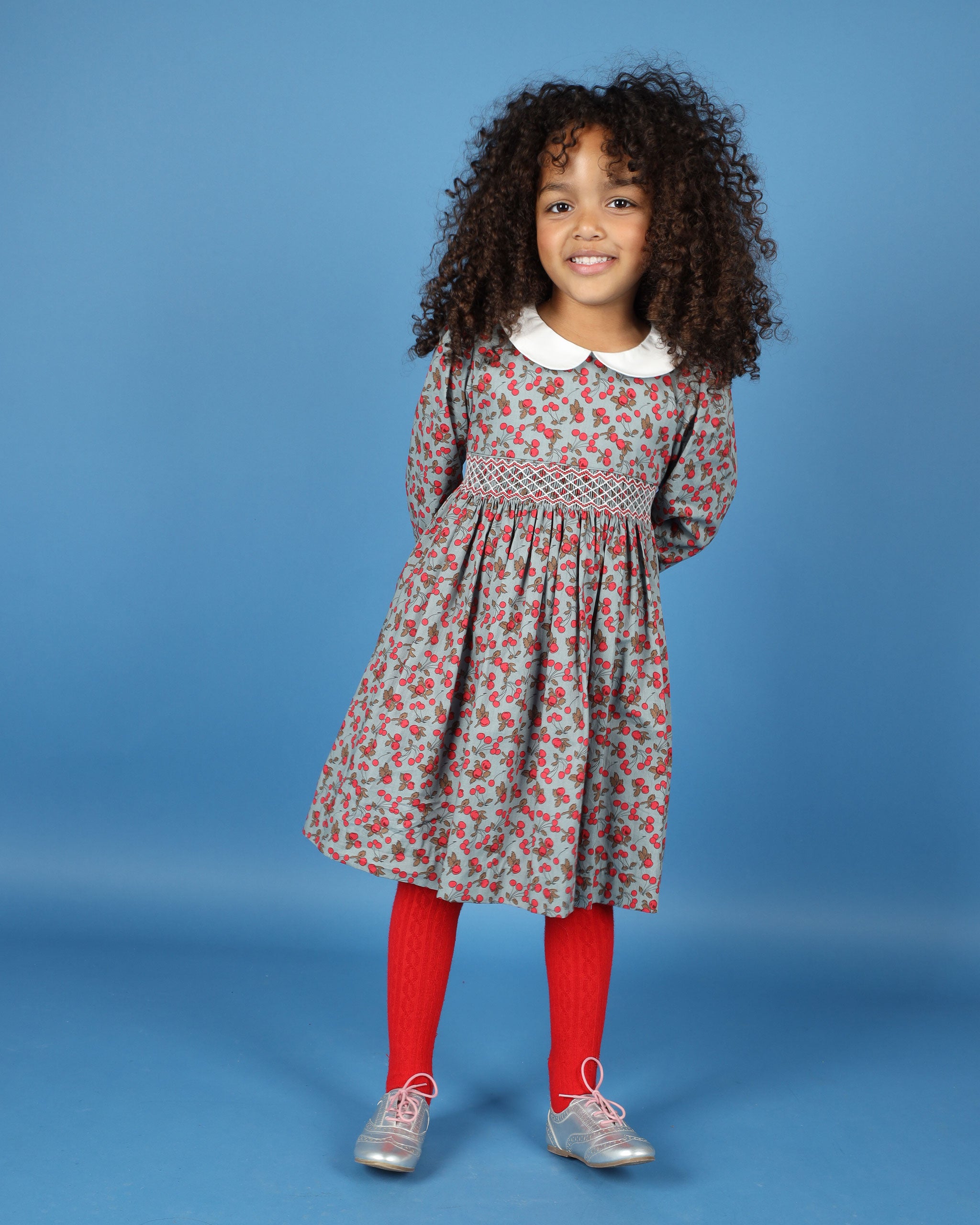 cherry print smock dress worn by girl