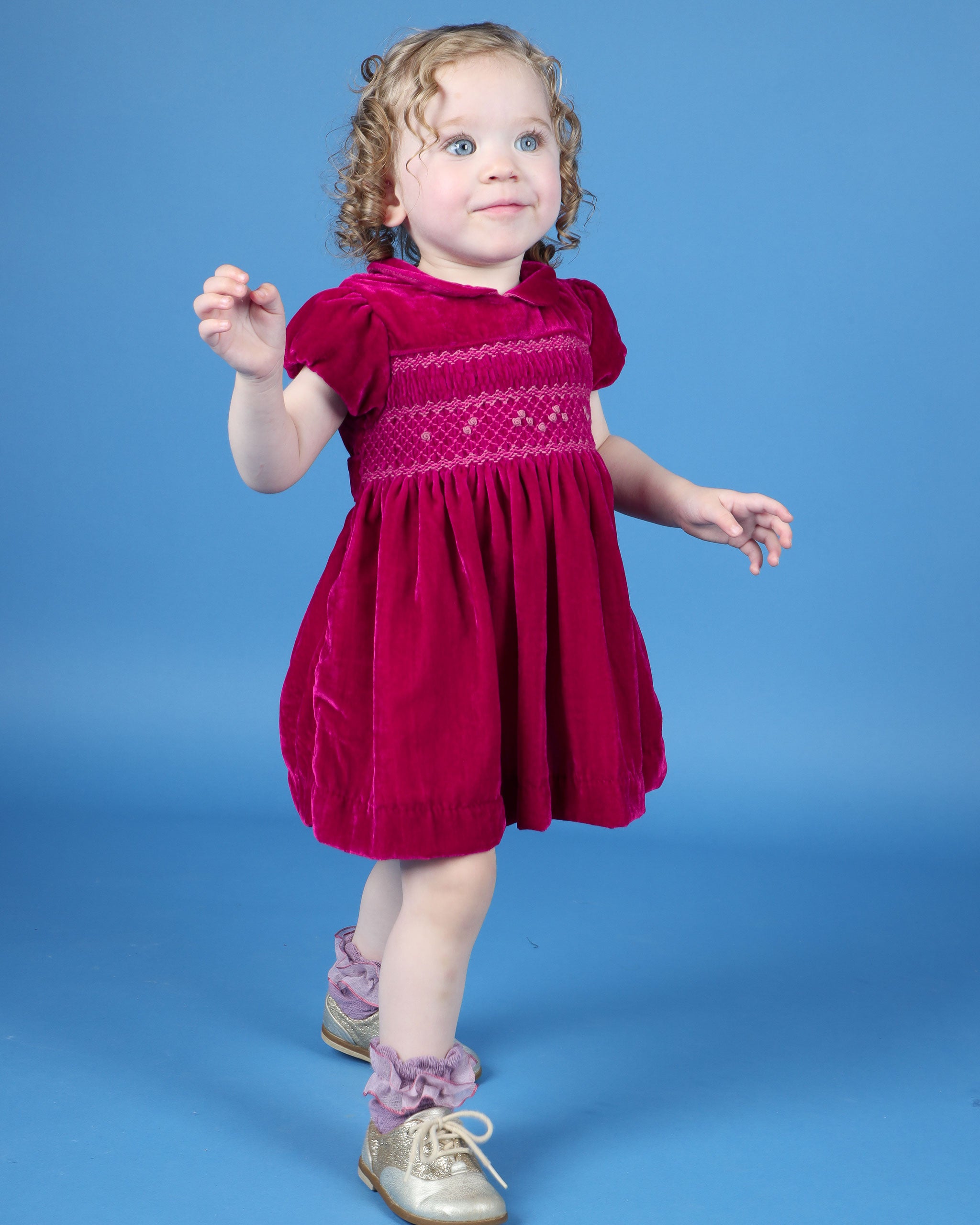 baby in pink velvet smock dress