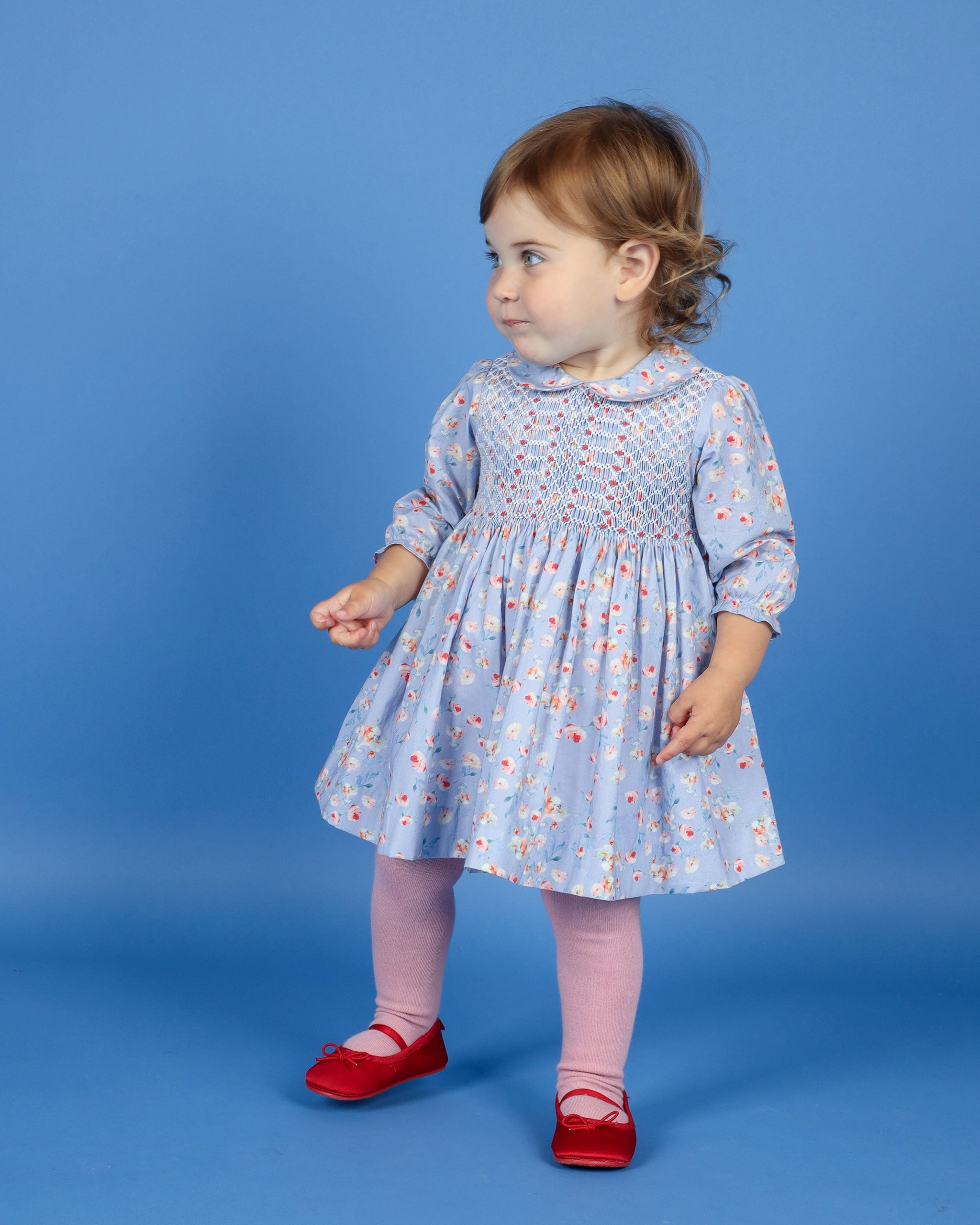 toddler in blue smocked dress