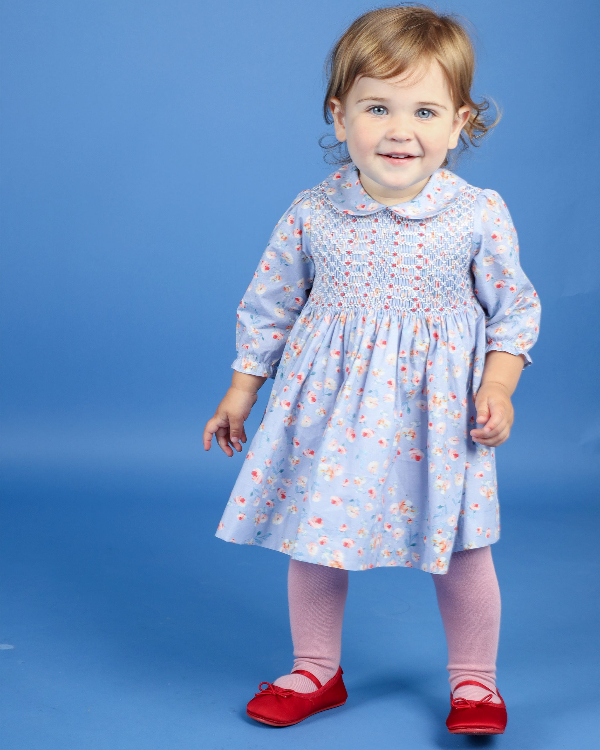 girl in baby blue dress with red flowers