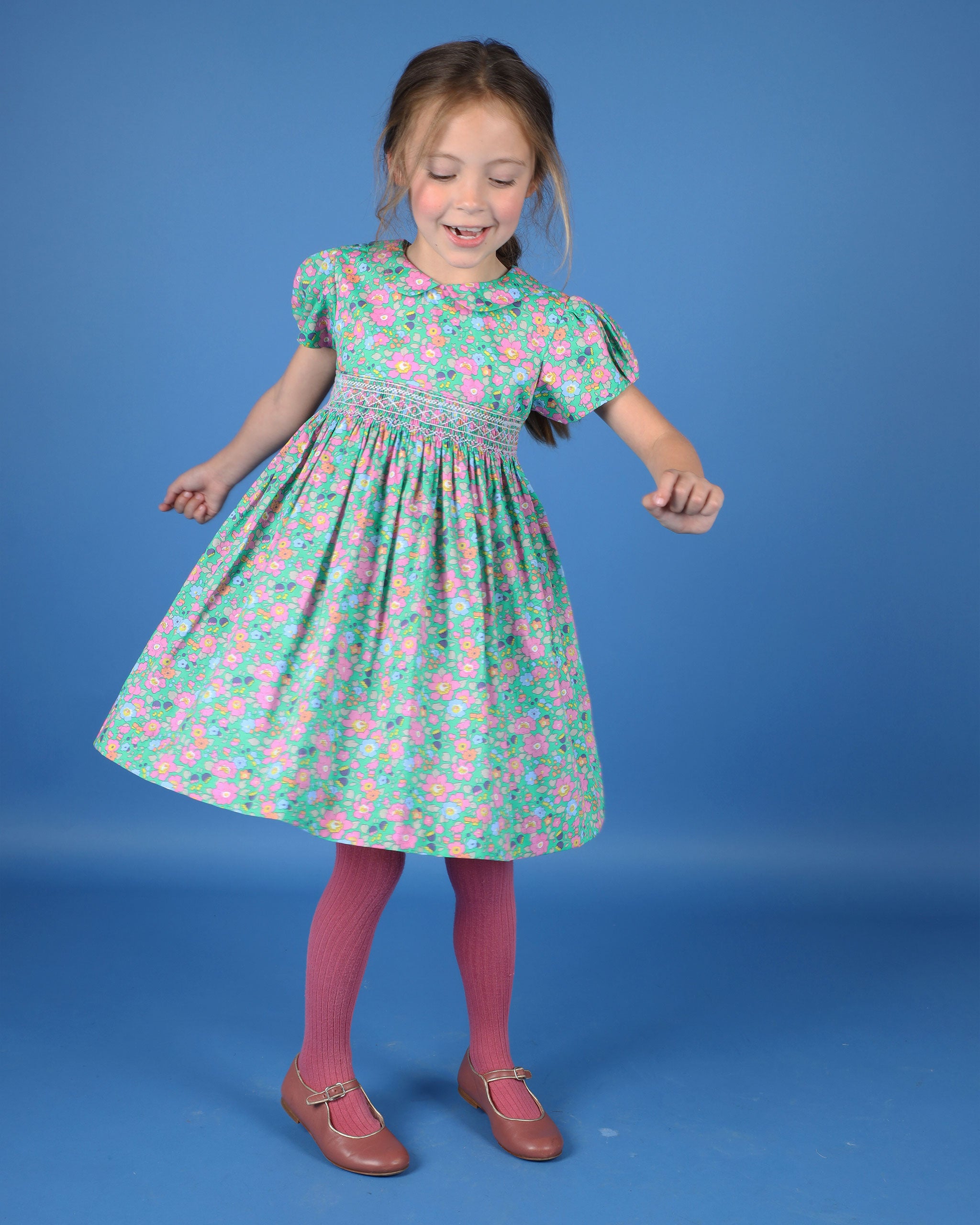 girl twirling in Liberty smock dress