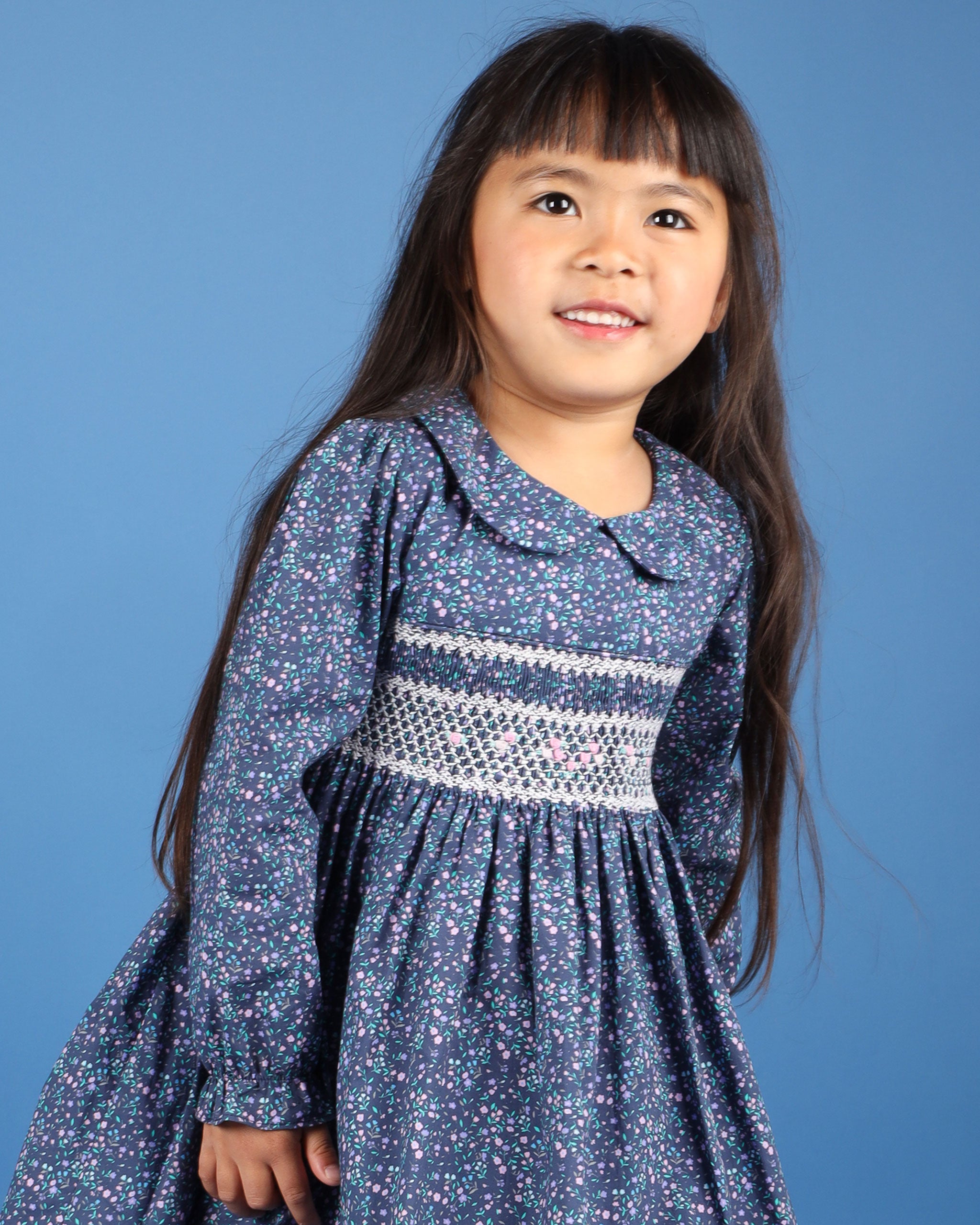 child model in festive smock dress