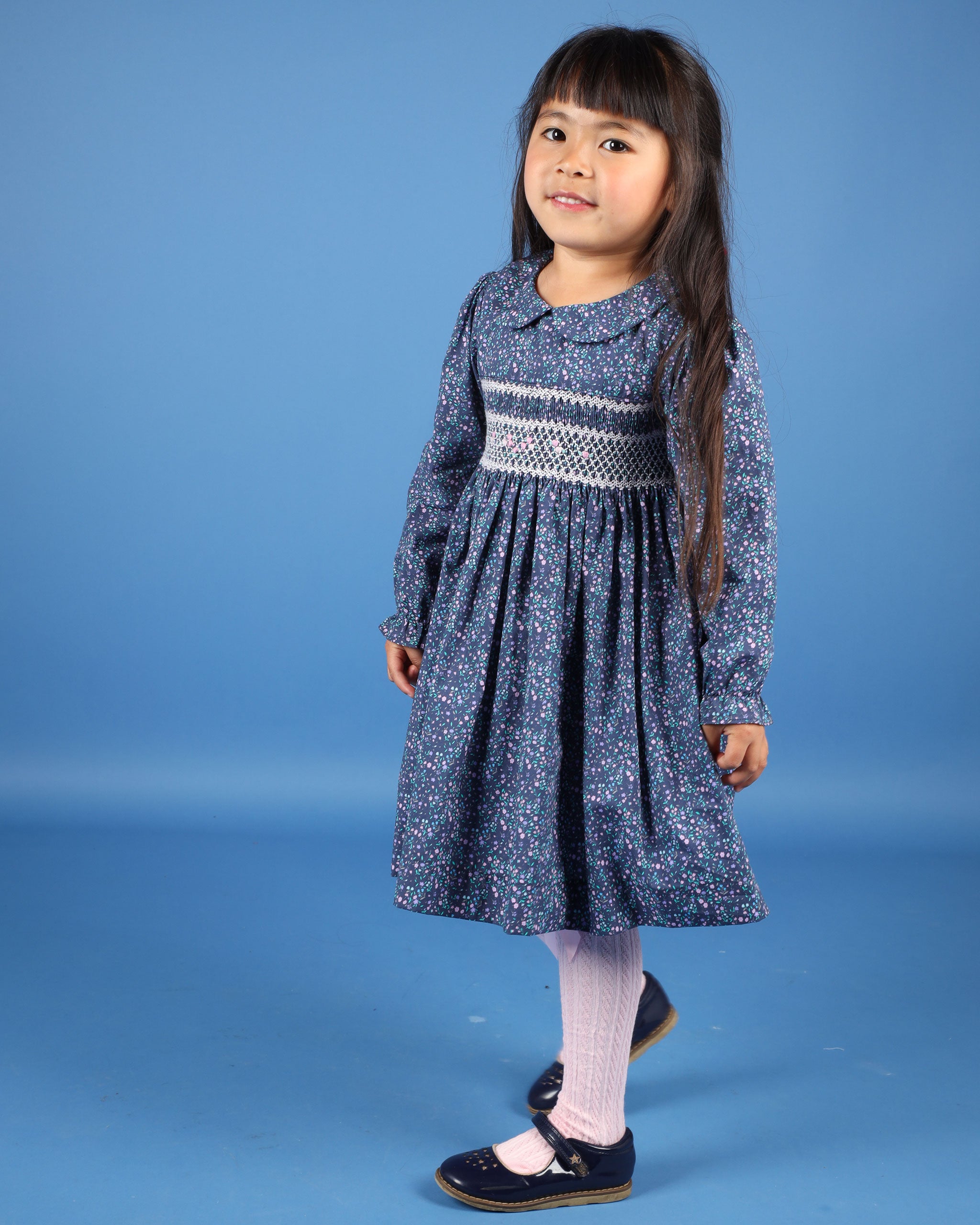 girls in navy  floral smock dress