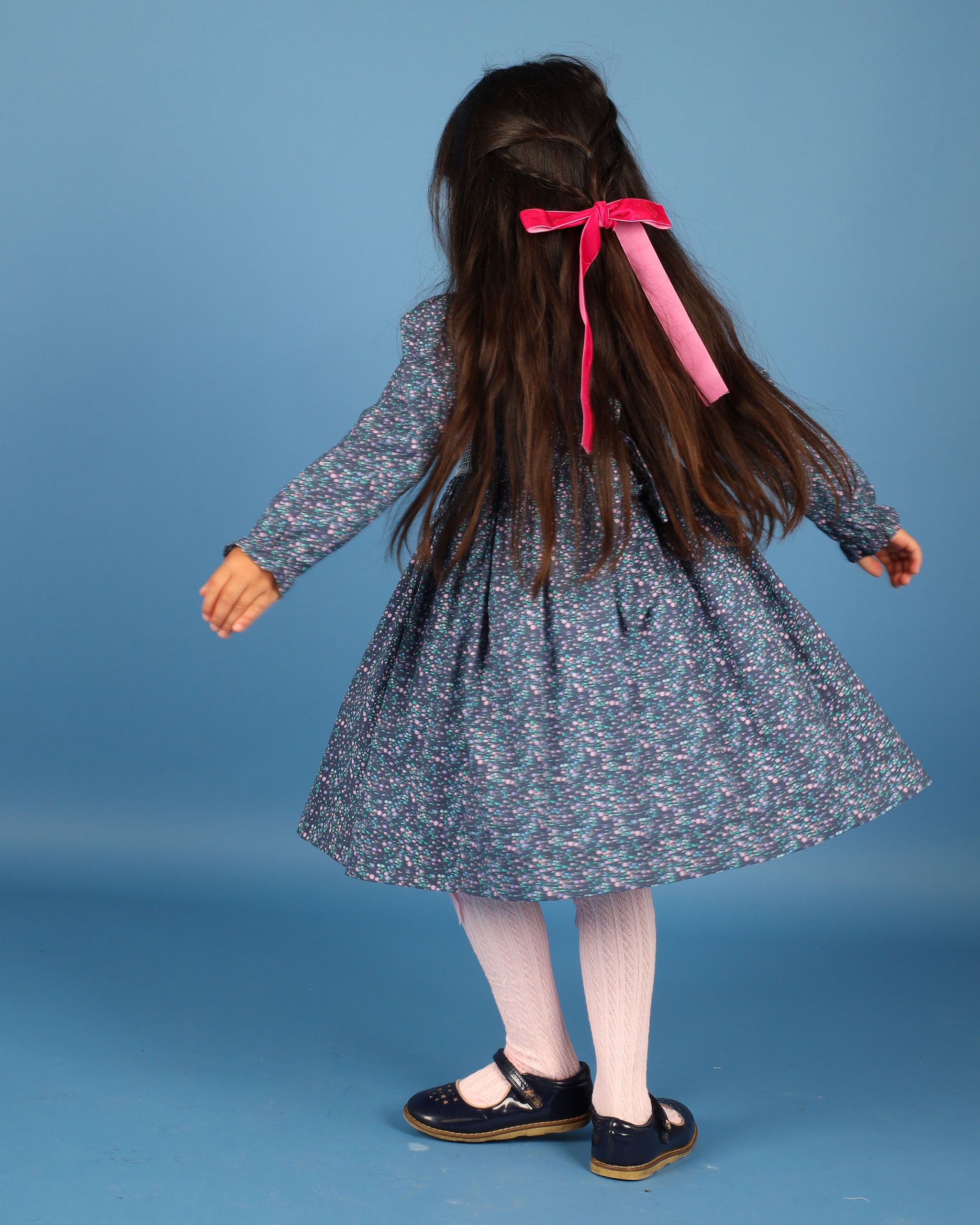 girl twirling in smocked dress