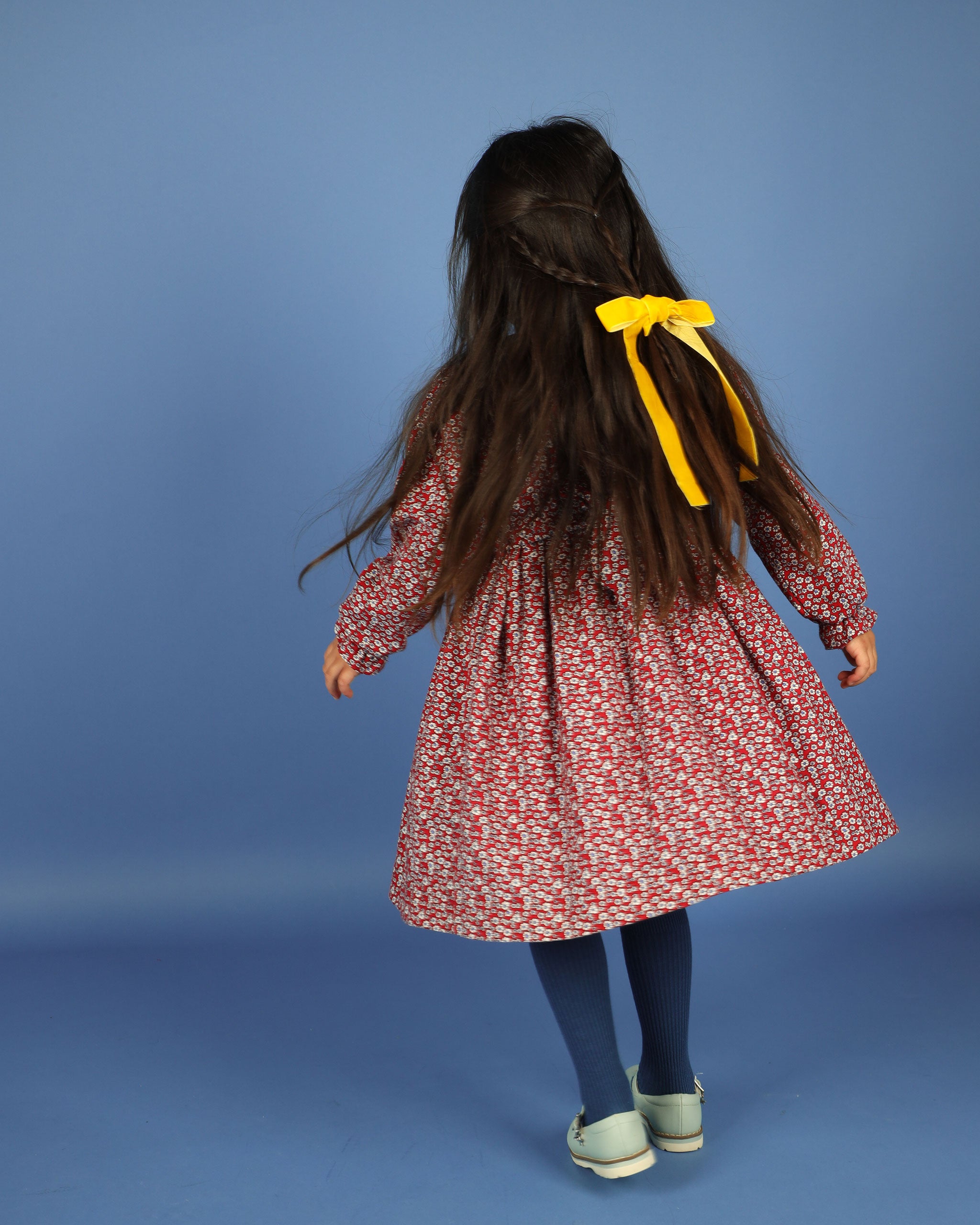 back of girl in red floral dress