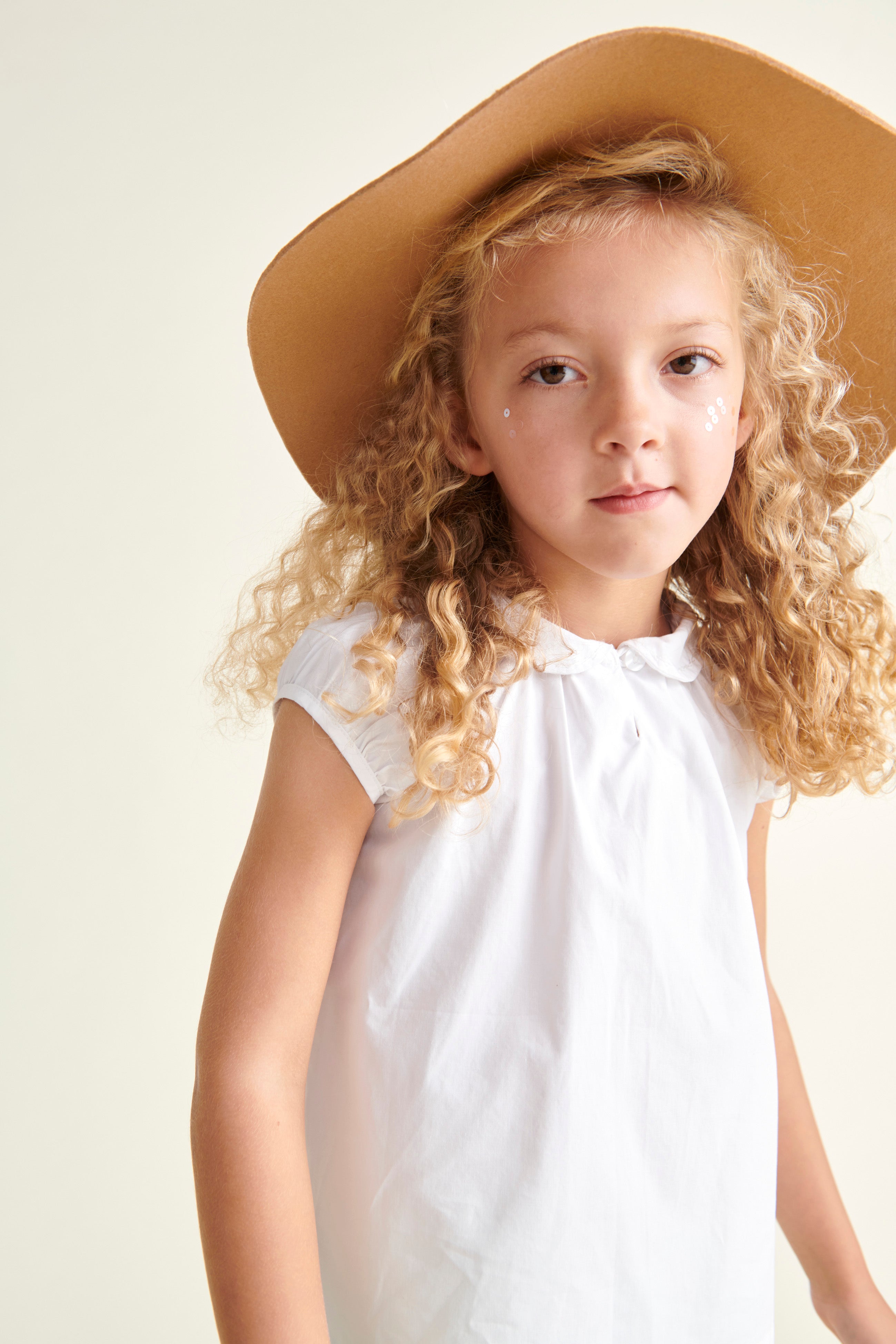 girl in white blouse and straw hat 