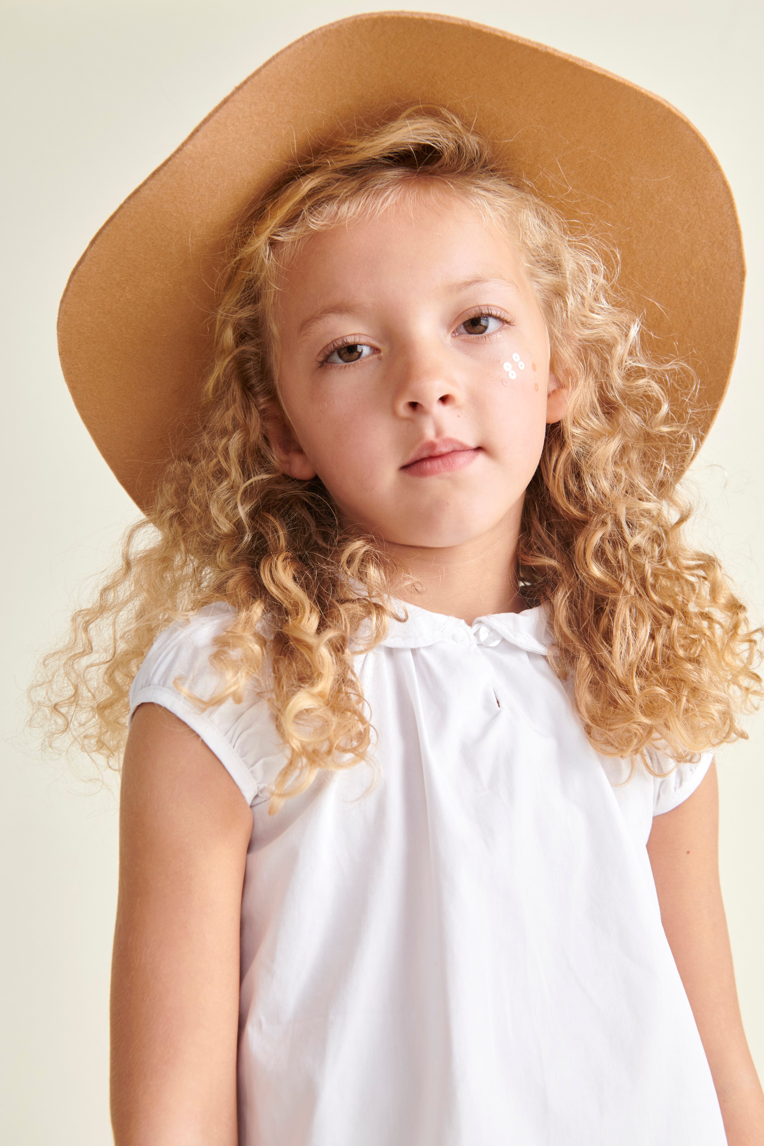 girl in straw hat and white cotton blouse
