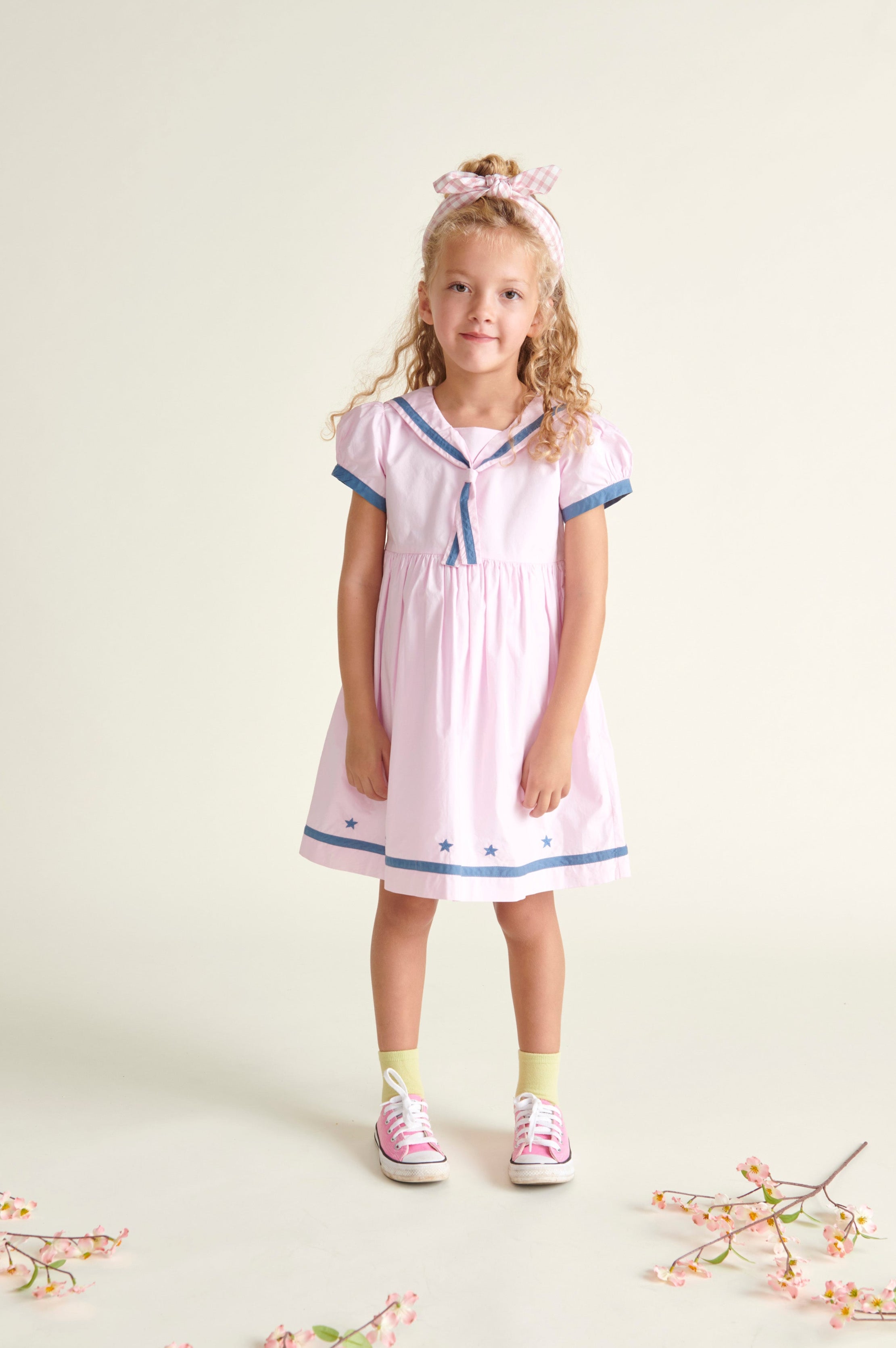 girl in pale pink sailor dress