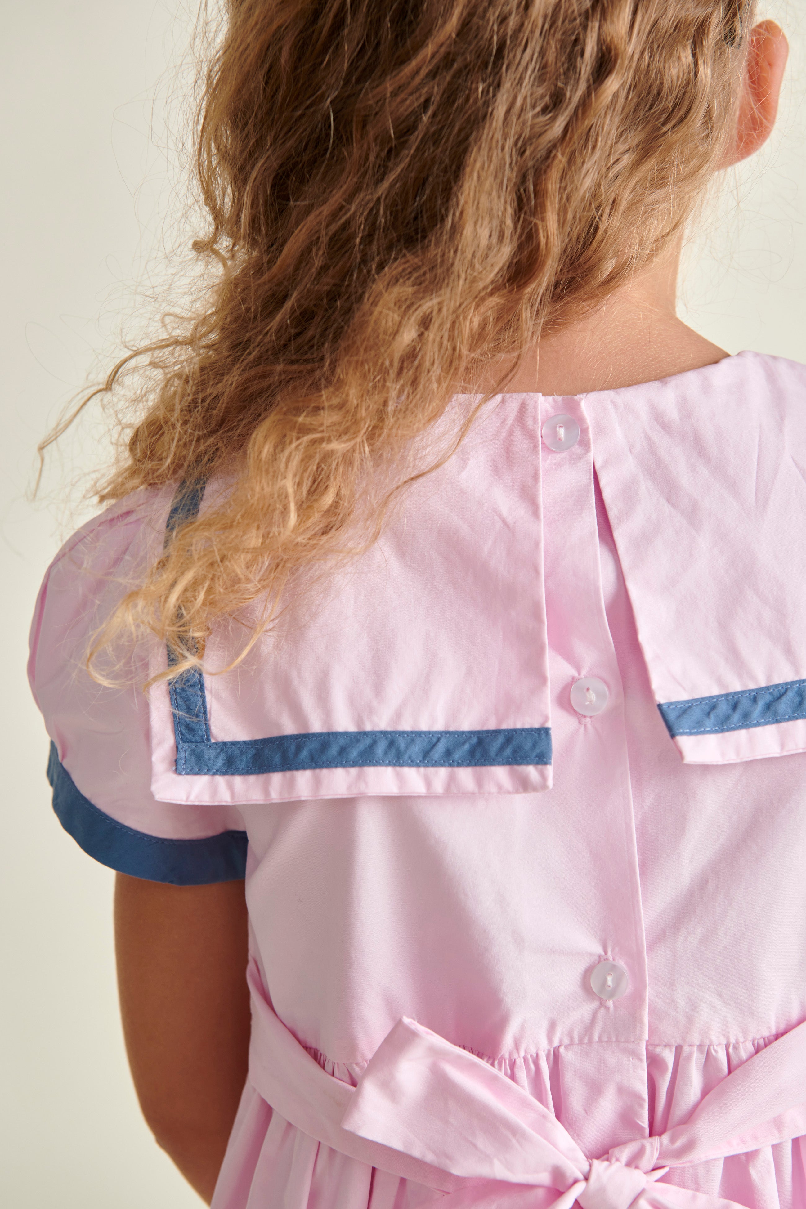 girl in sailor dress, back , closeup of collar