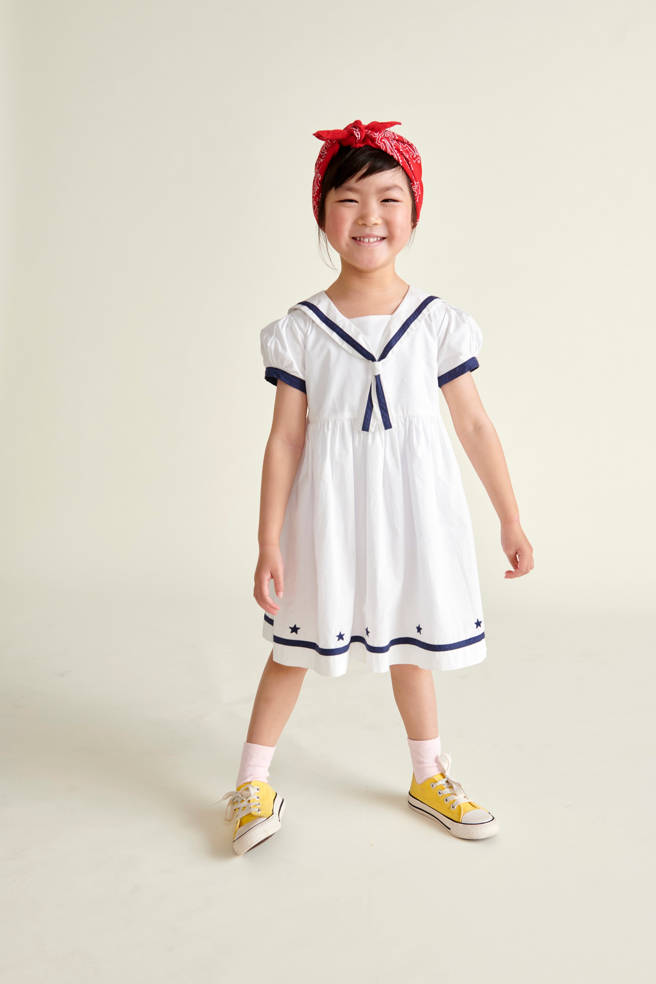 girl in sailor dress smiling