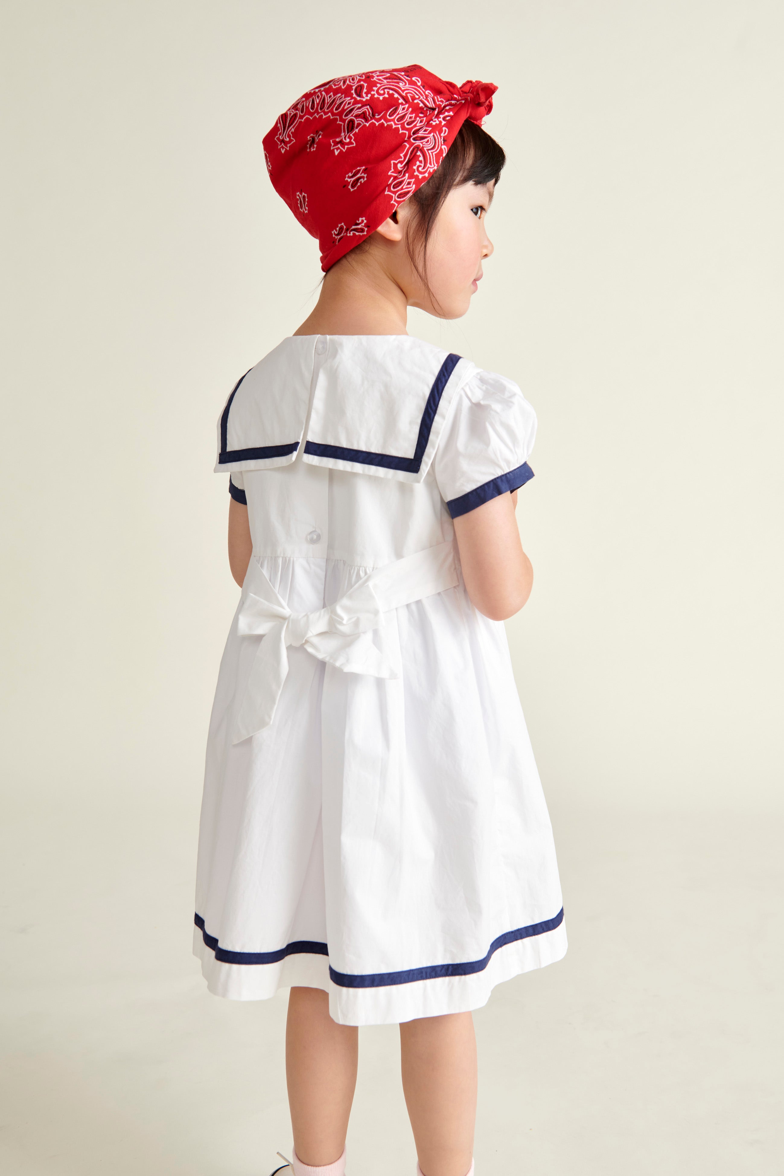 girl in sailor dress, back view