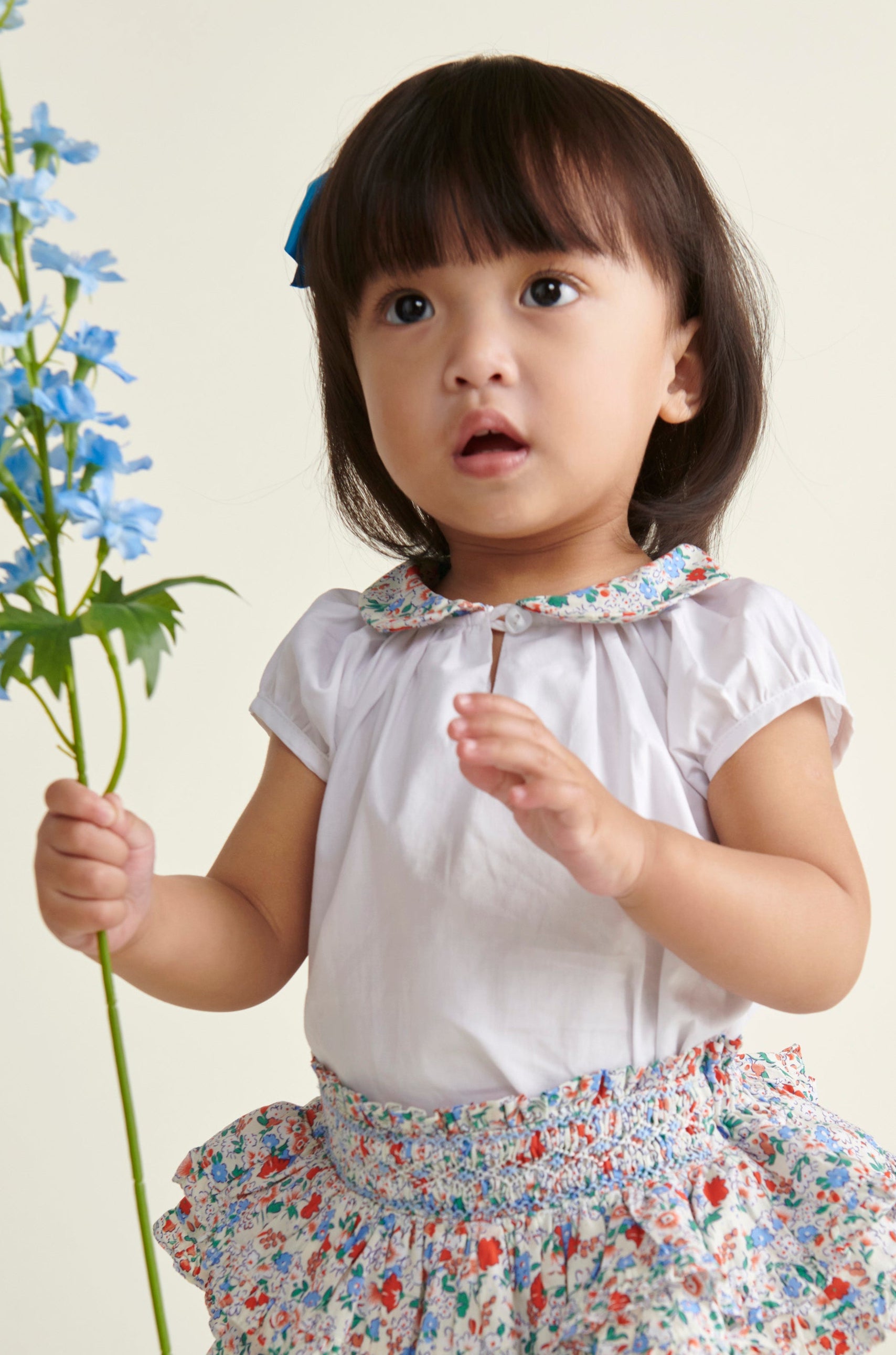 toddler gir in white blouse