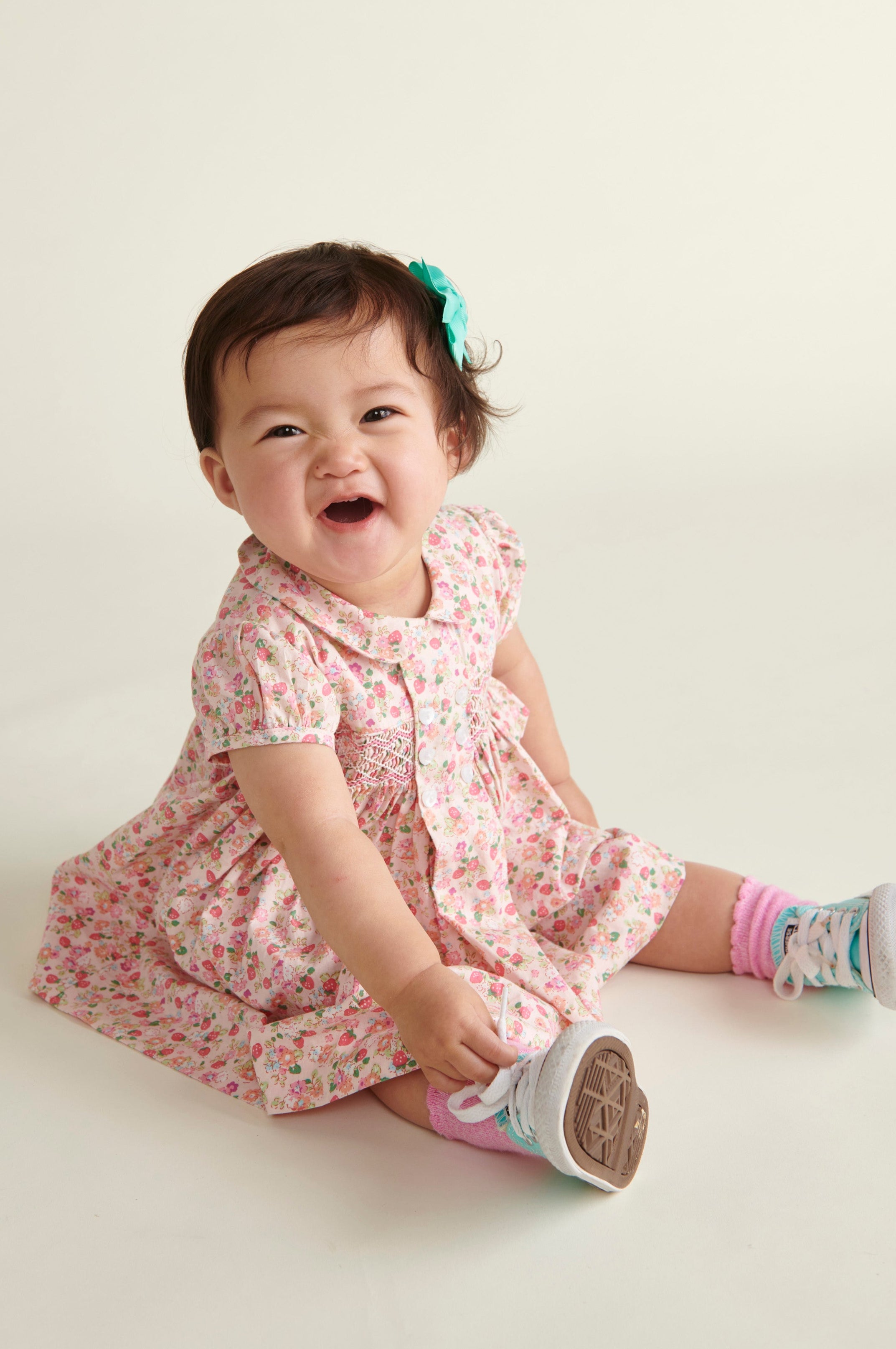 baby in strawberry dress, sitting