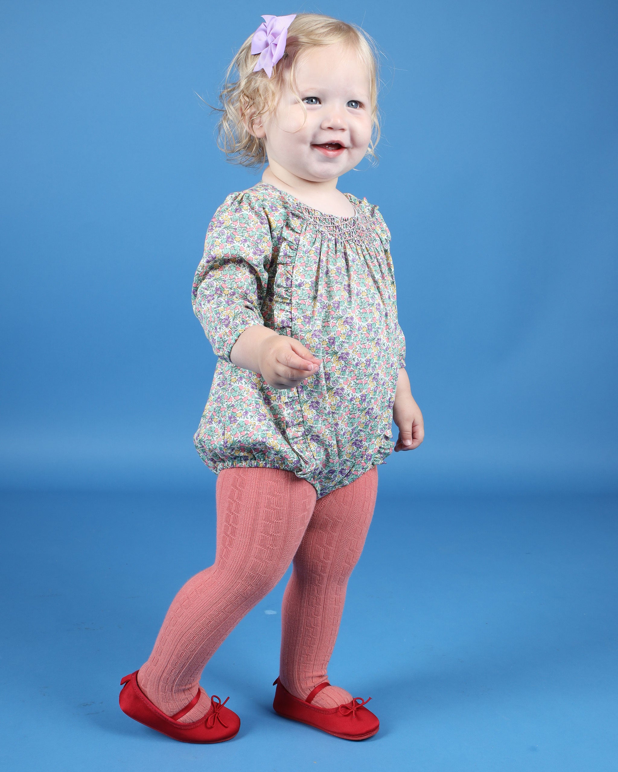 toddler in smocked romper