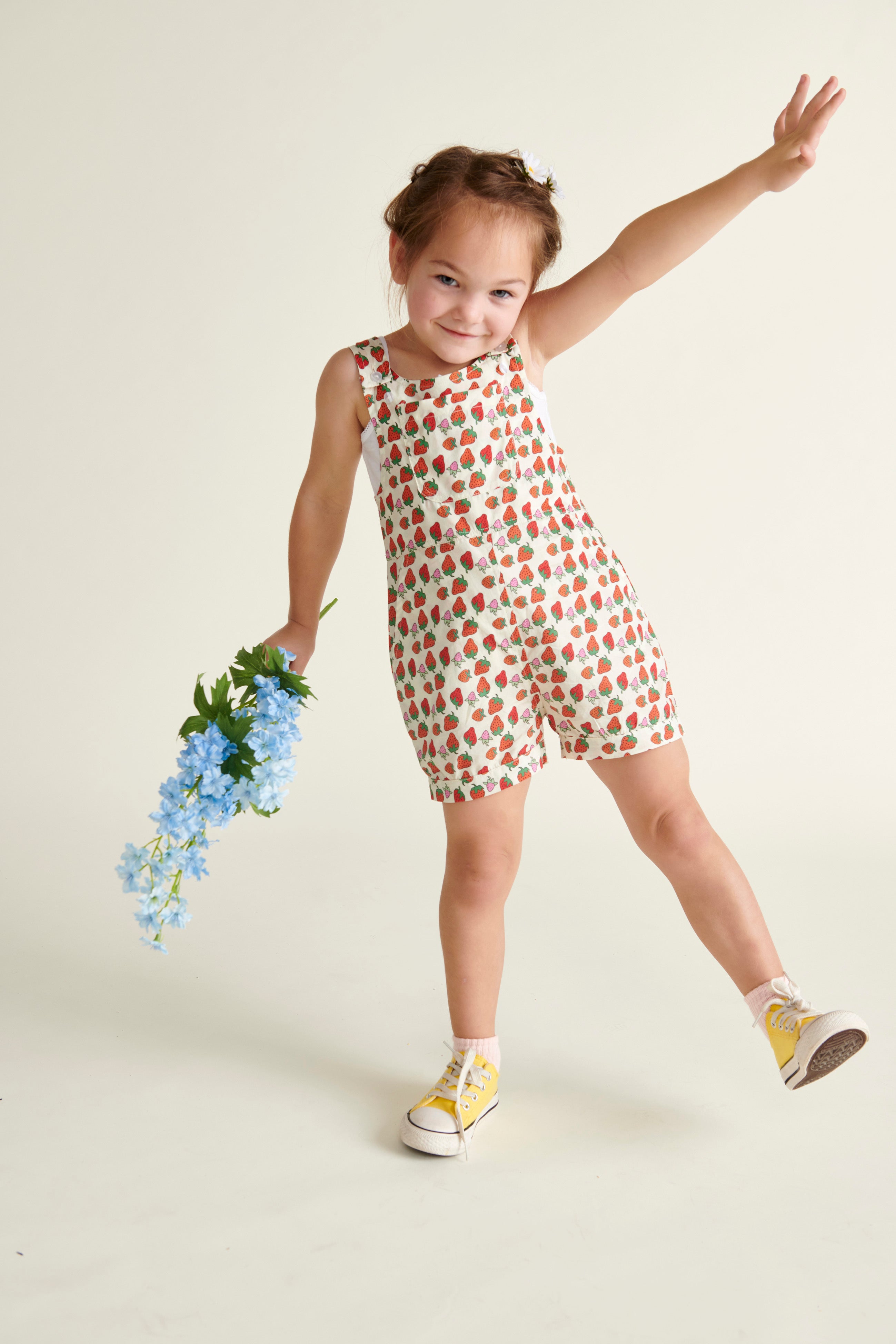 girl in  strawberry dungarees