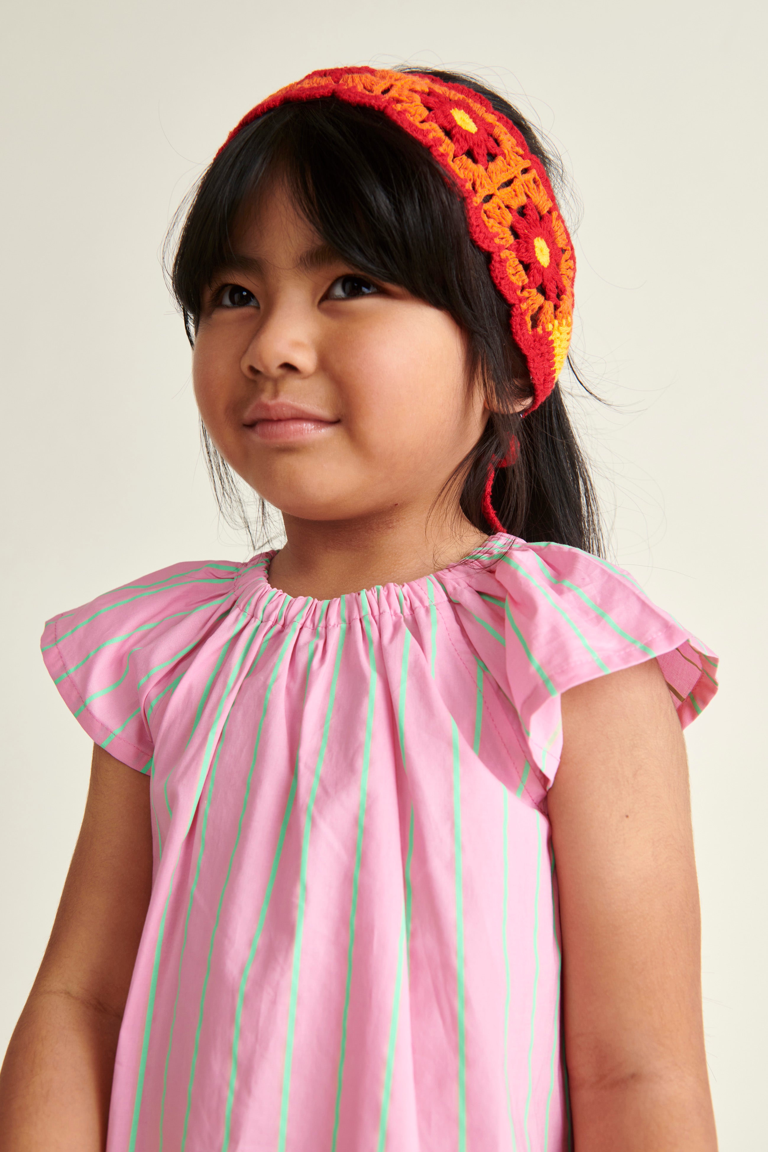 girl in pink blouse with neon pinstripes