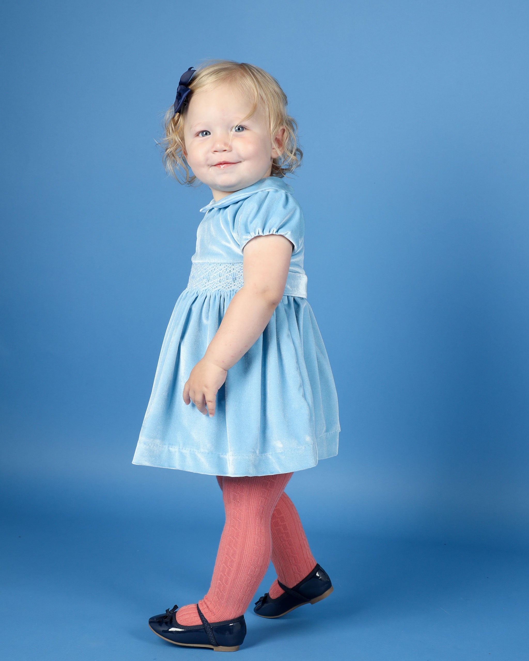 baby in smocked dress made from pale blue velvet