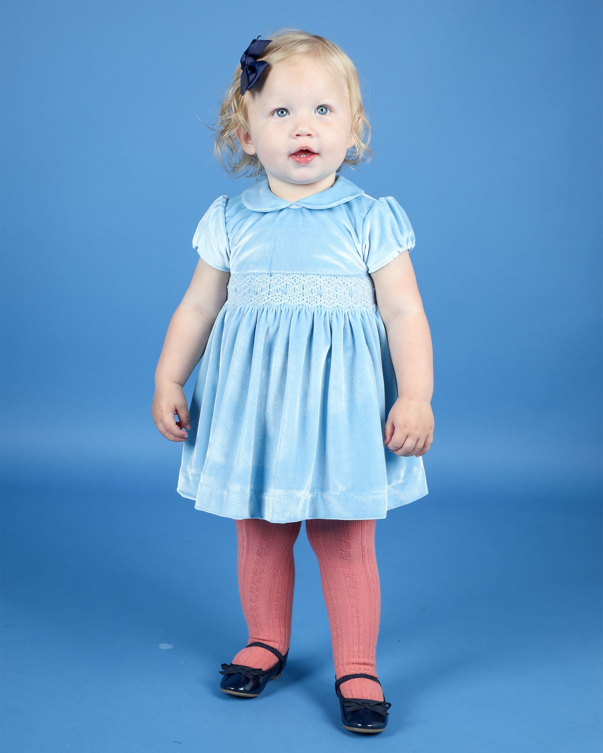 baby in blue velvet dress
