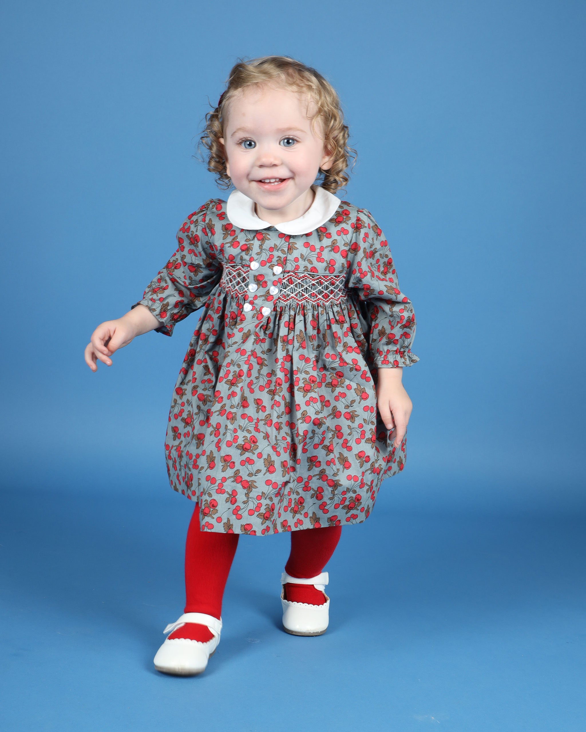 toddler in cherry print dress