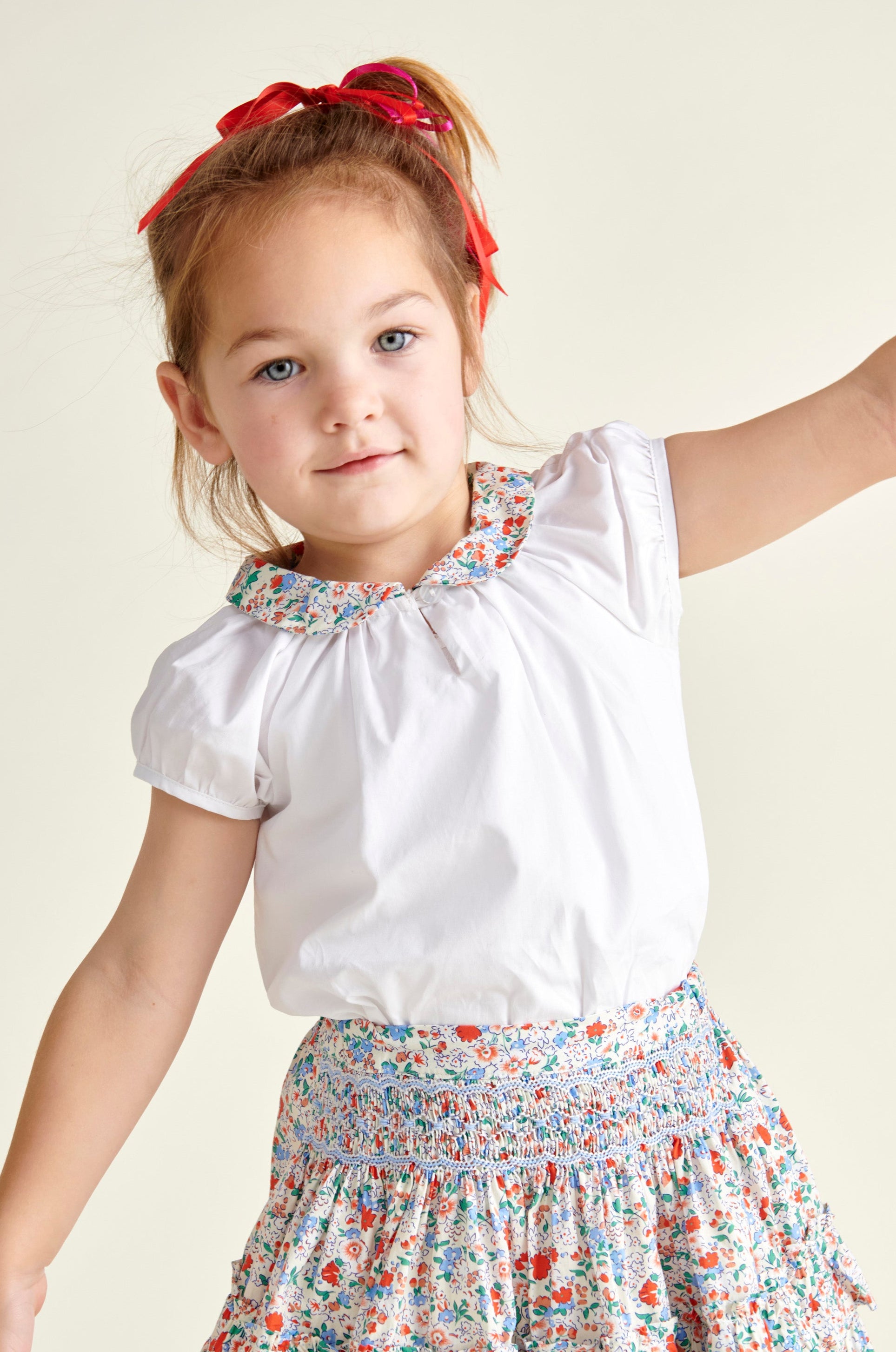 girl wearing white blouse and floral skirt