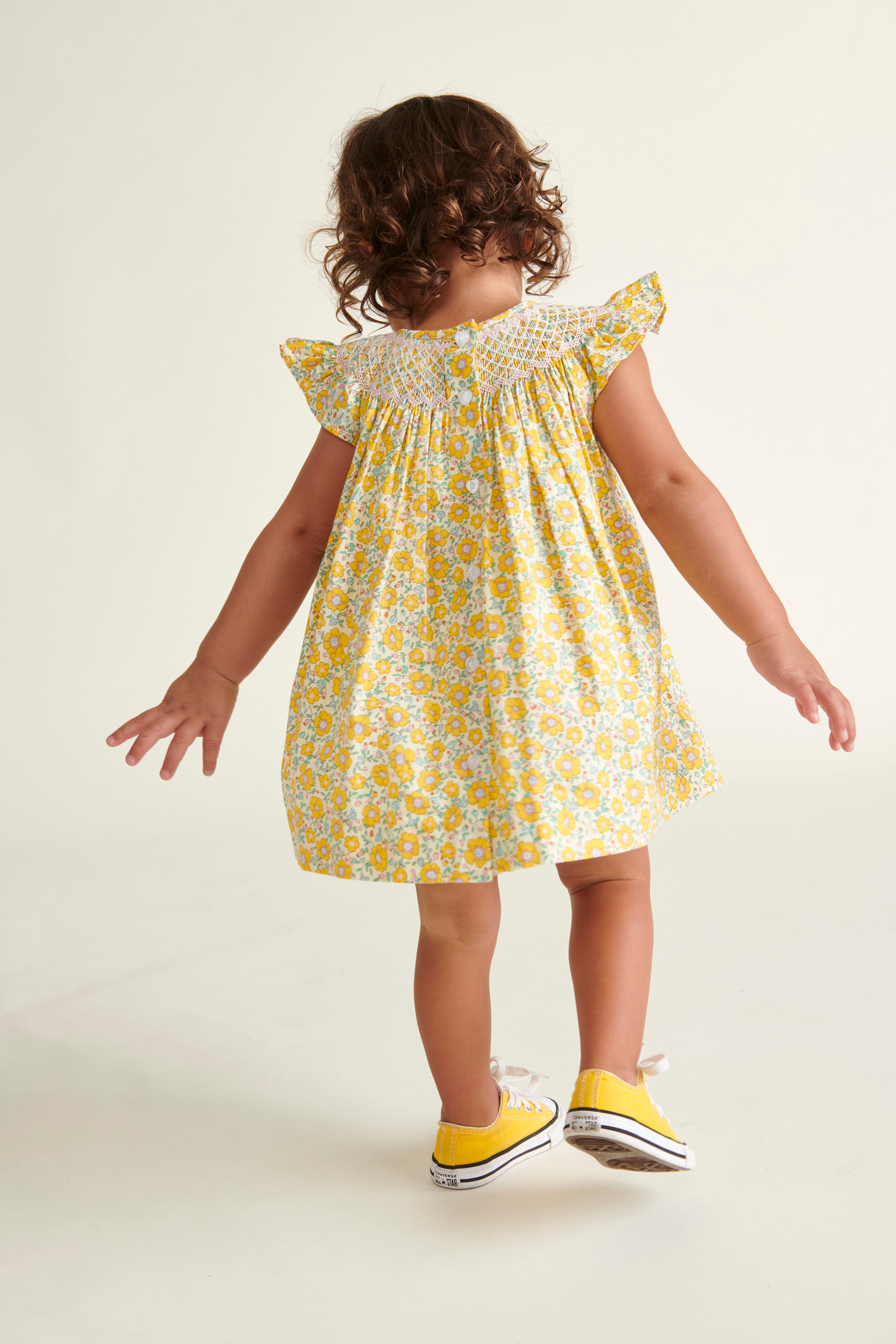 girl in yellow dress with frill sleeves