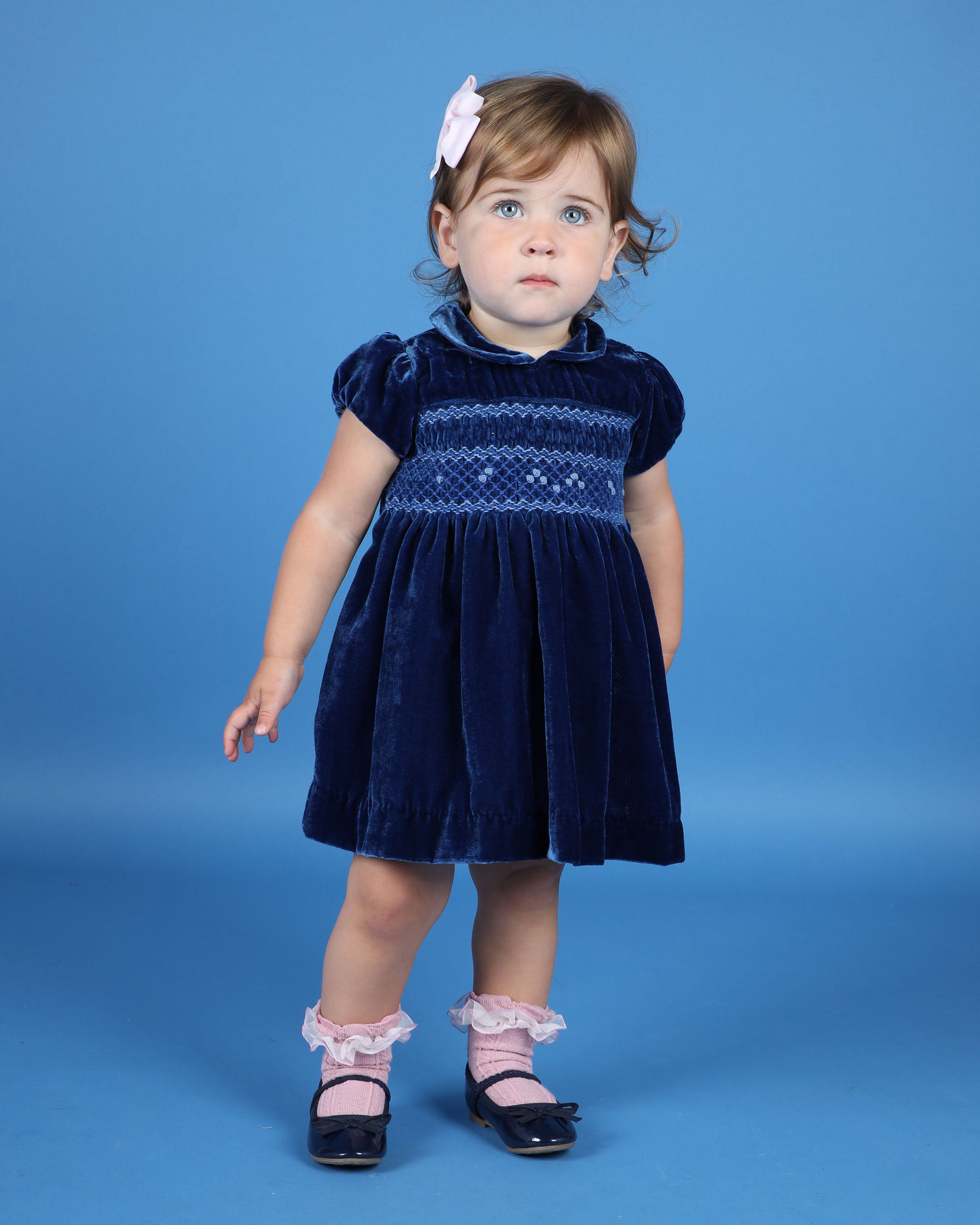 baby girl in velvet party dress with smocking