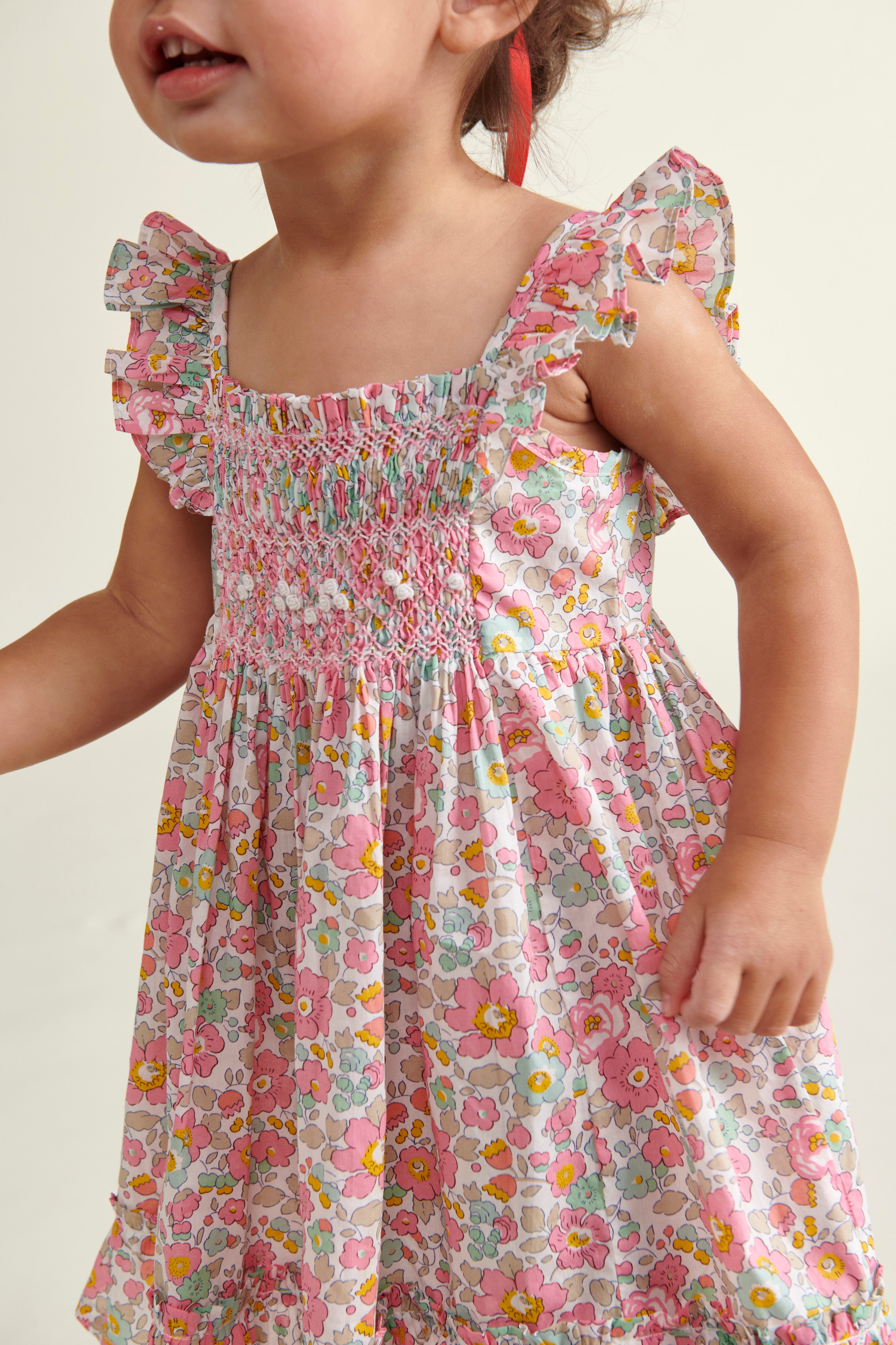 toddler girl in Liberty print sun dress, closeup