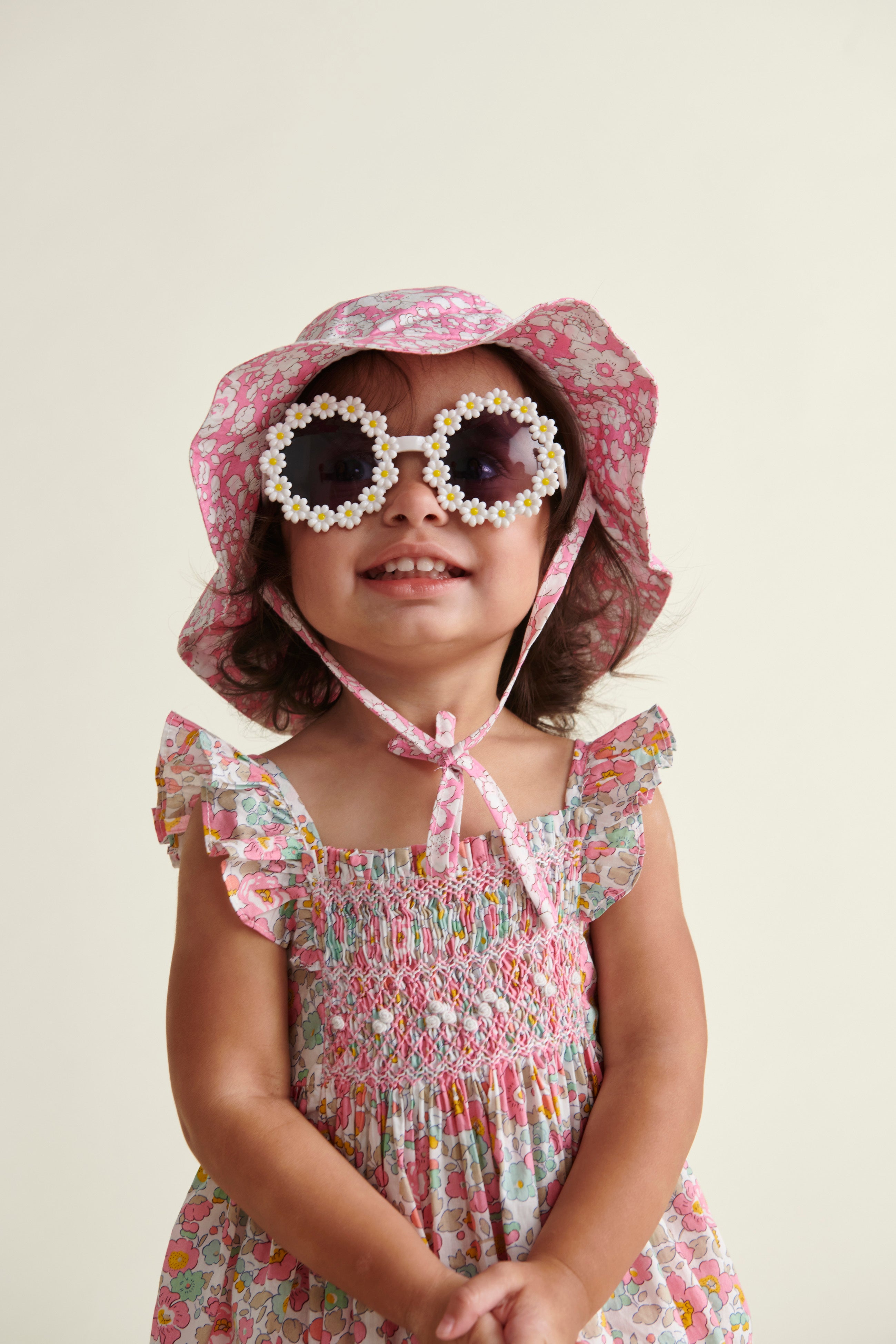 Liberty print sun hat worn by smiling baby