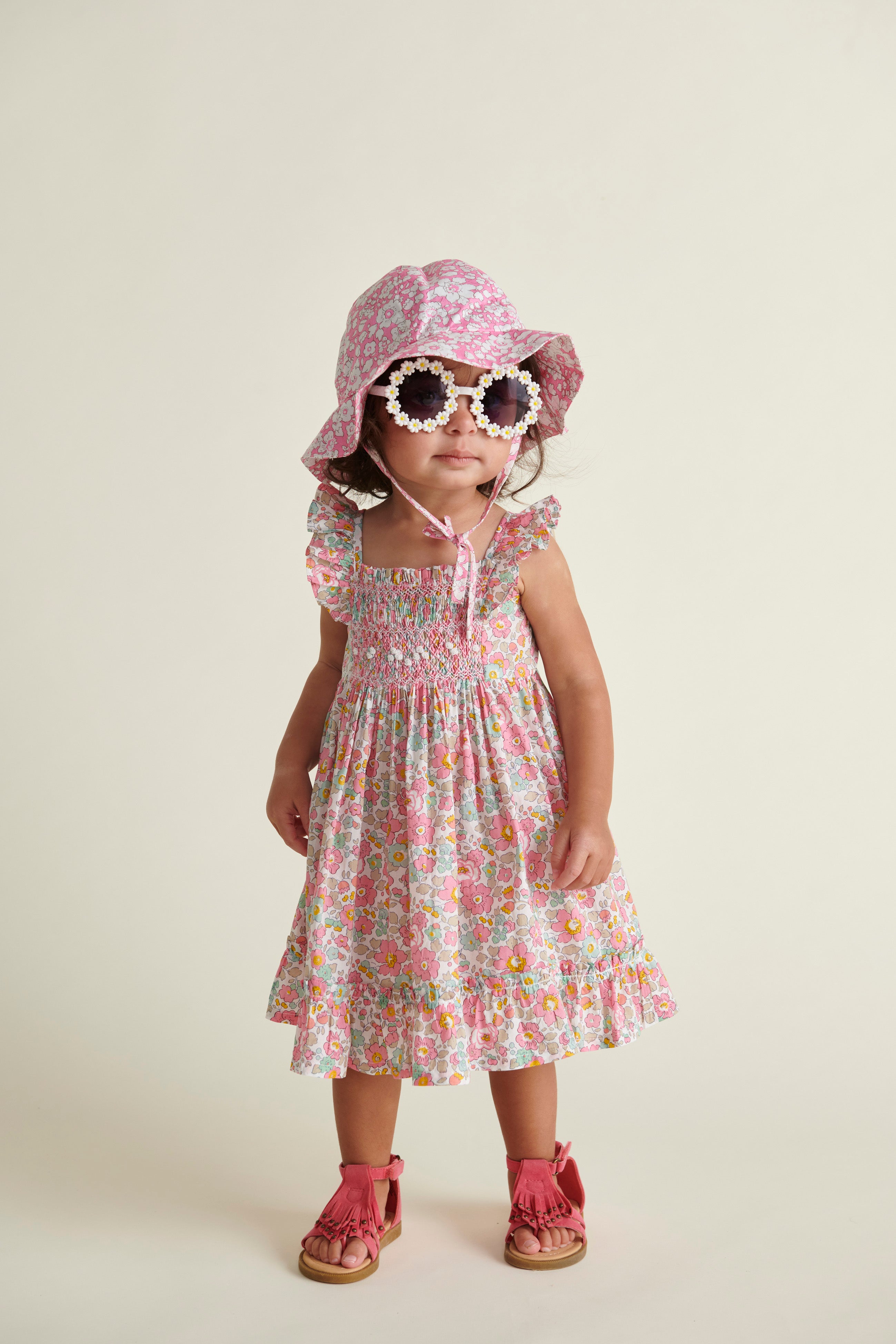 Liberty print sun hat and dress worn by baby