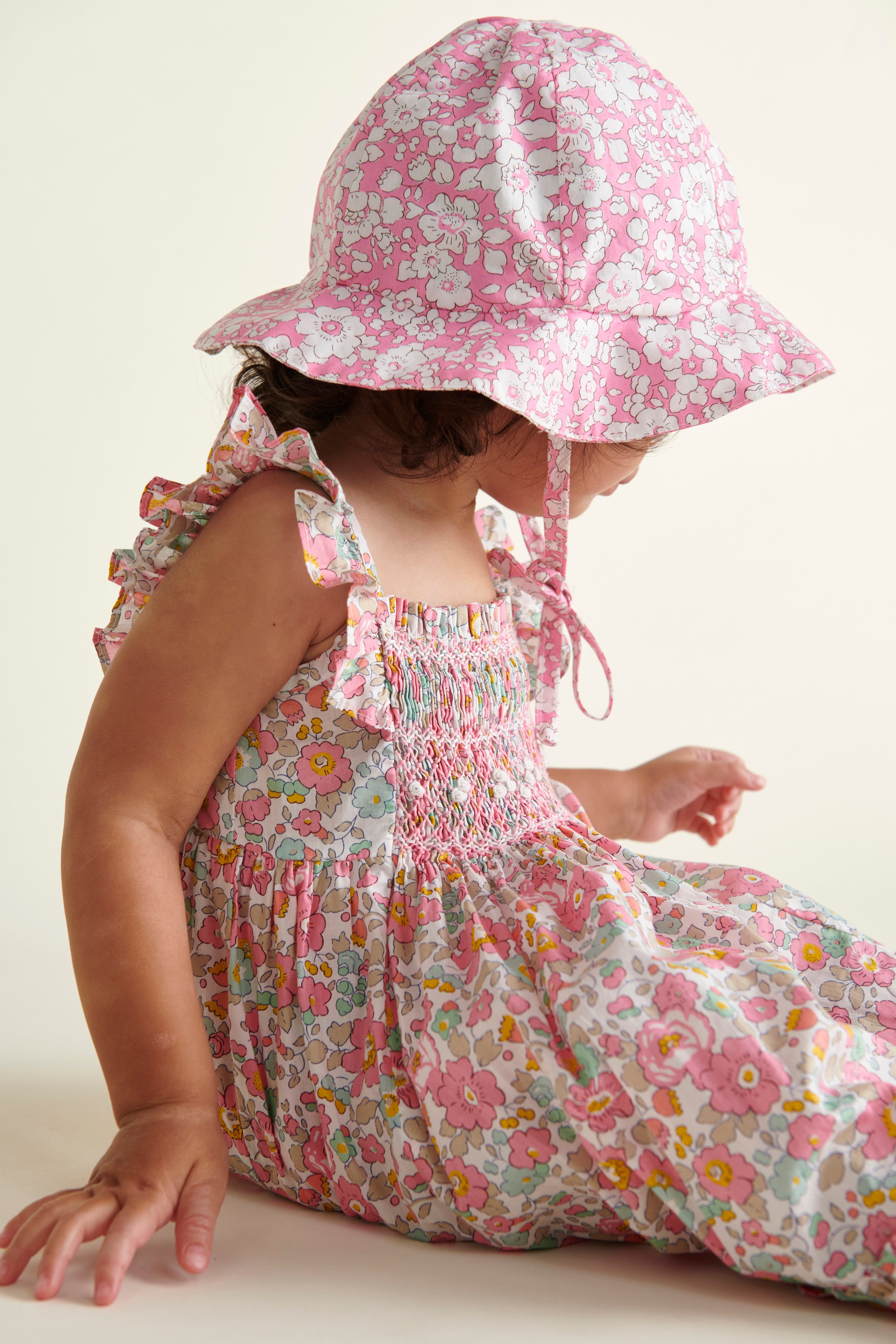 Liberty print sun hat worn by baby, side view