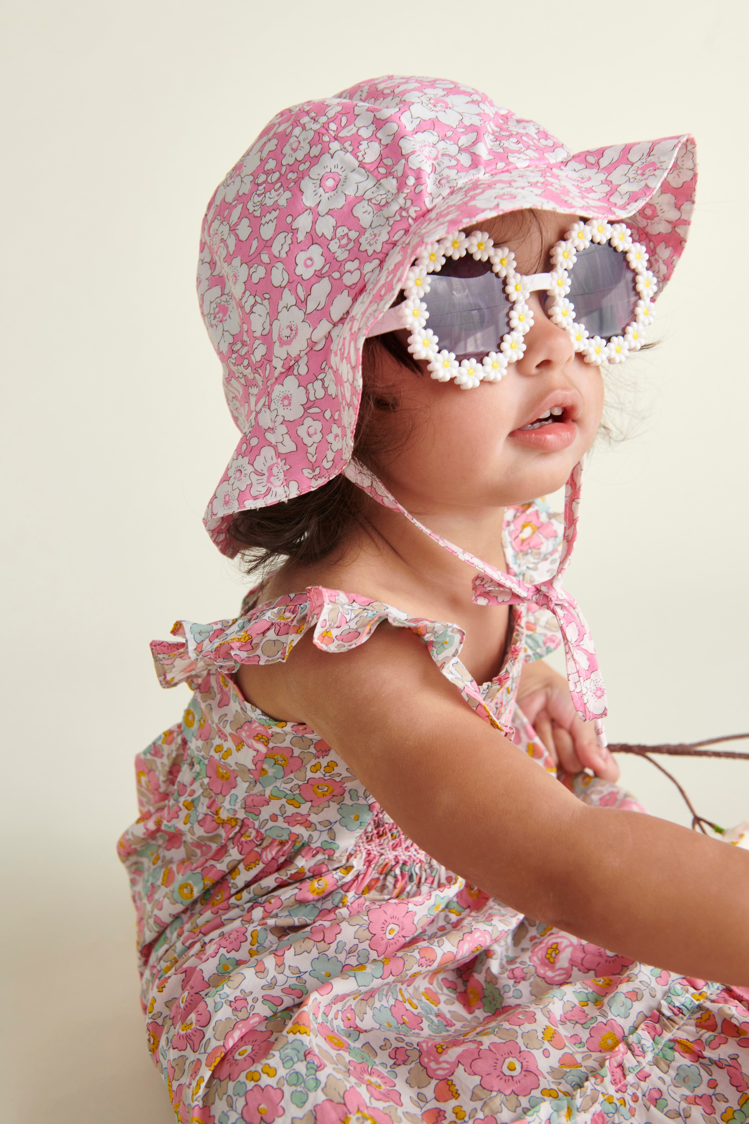 Pink Liberty print sun hat worn by baby