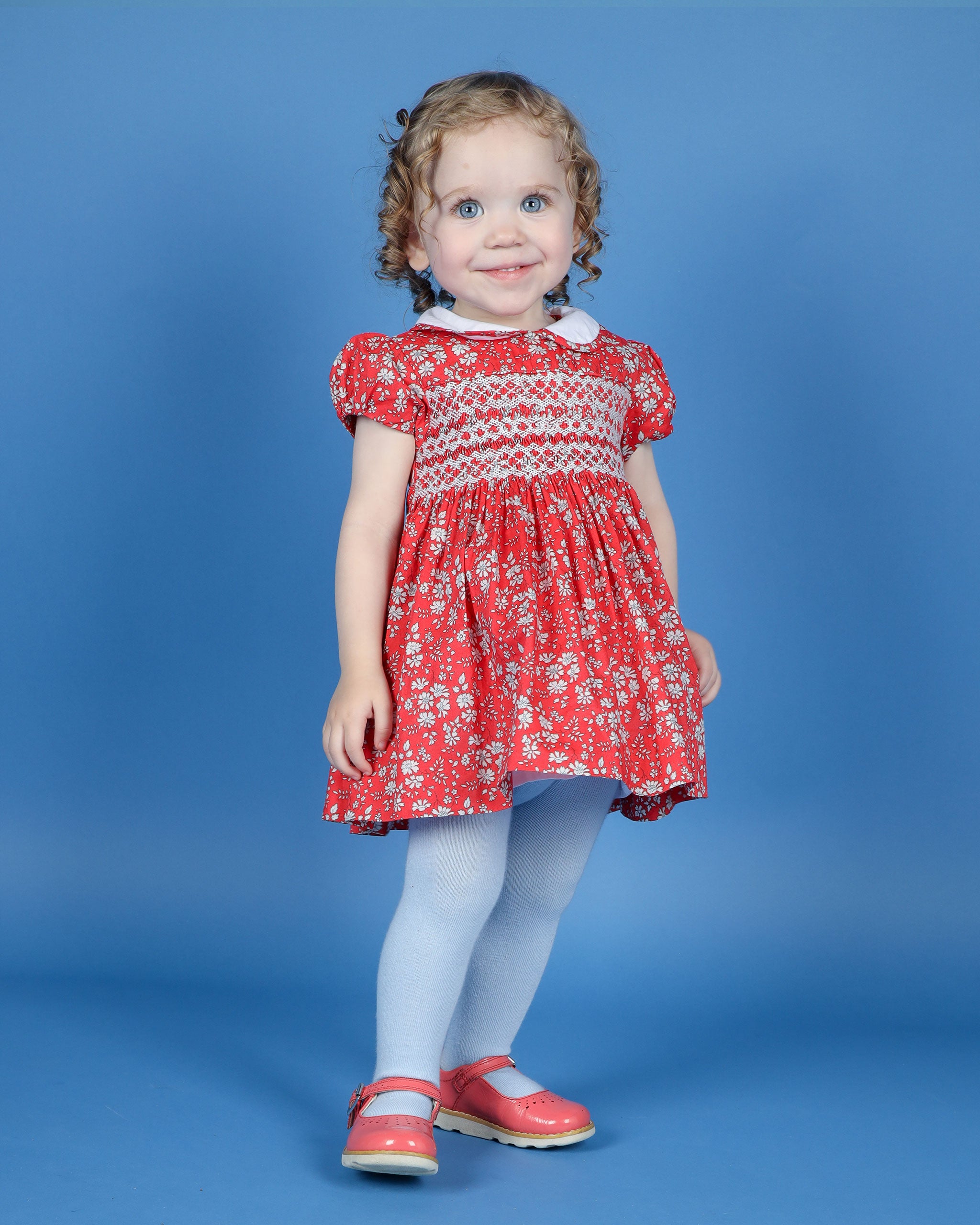 girl in red floral dress made from Liberty Fabric, hand-smocked