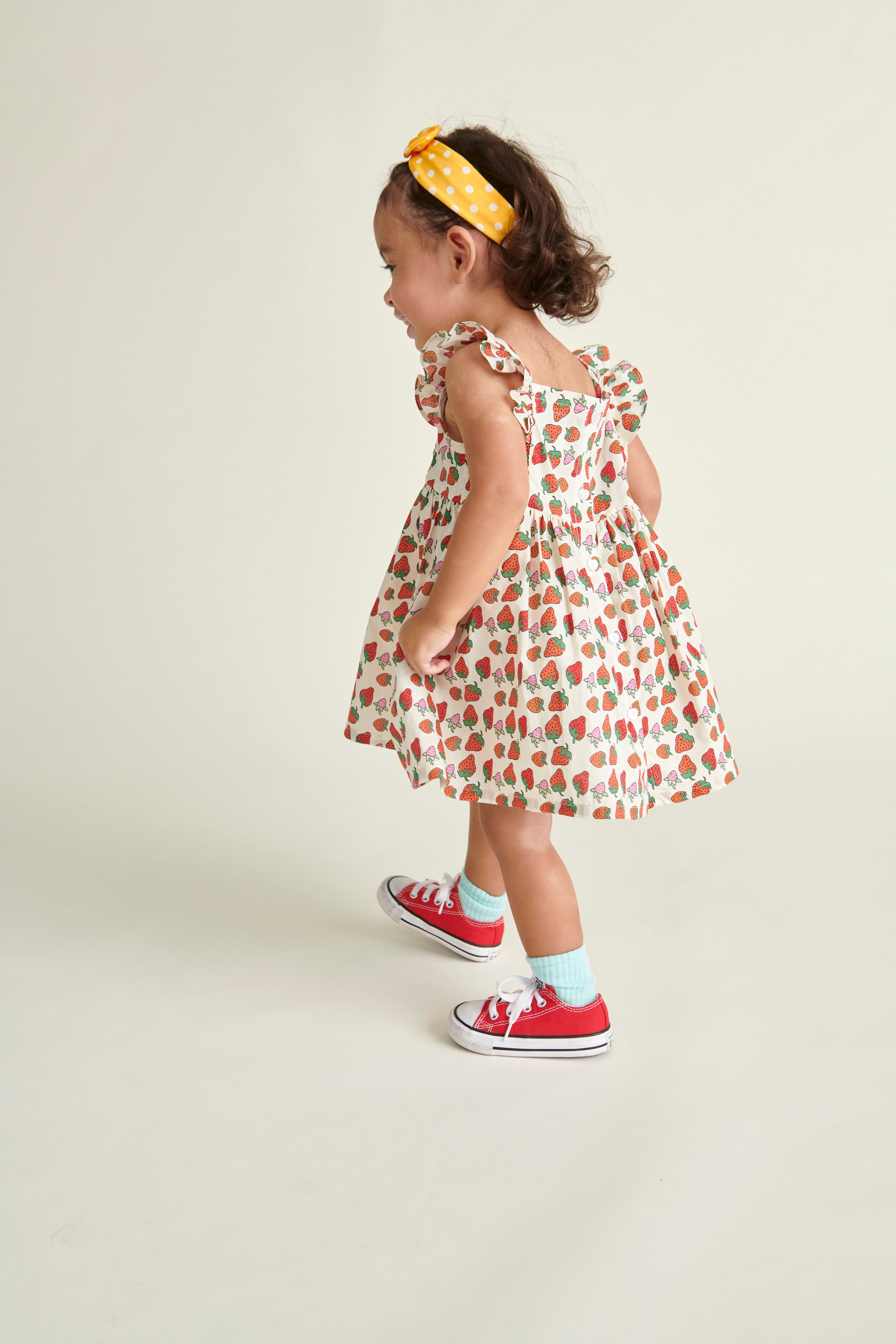 toddler girl i n Strawberry sun dress, back