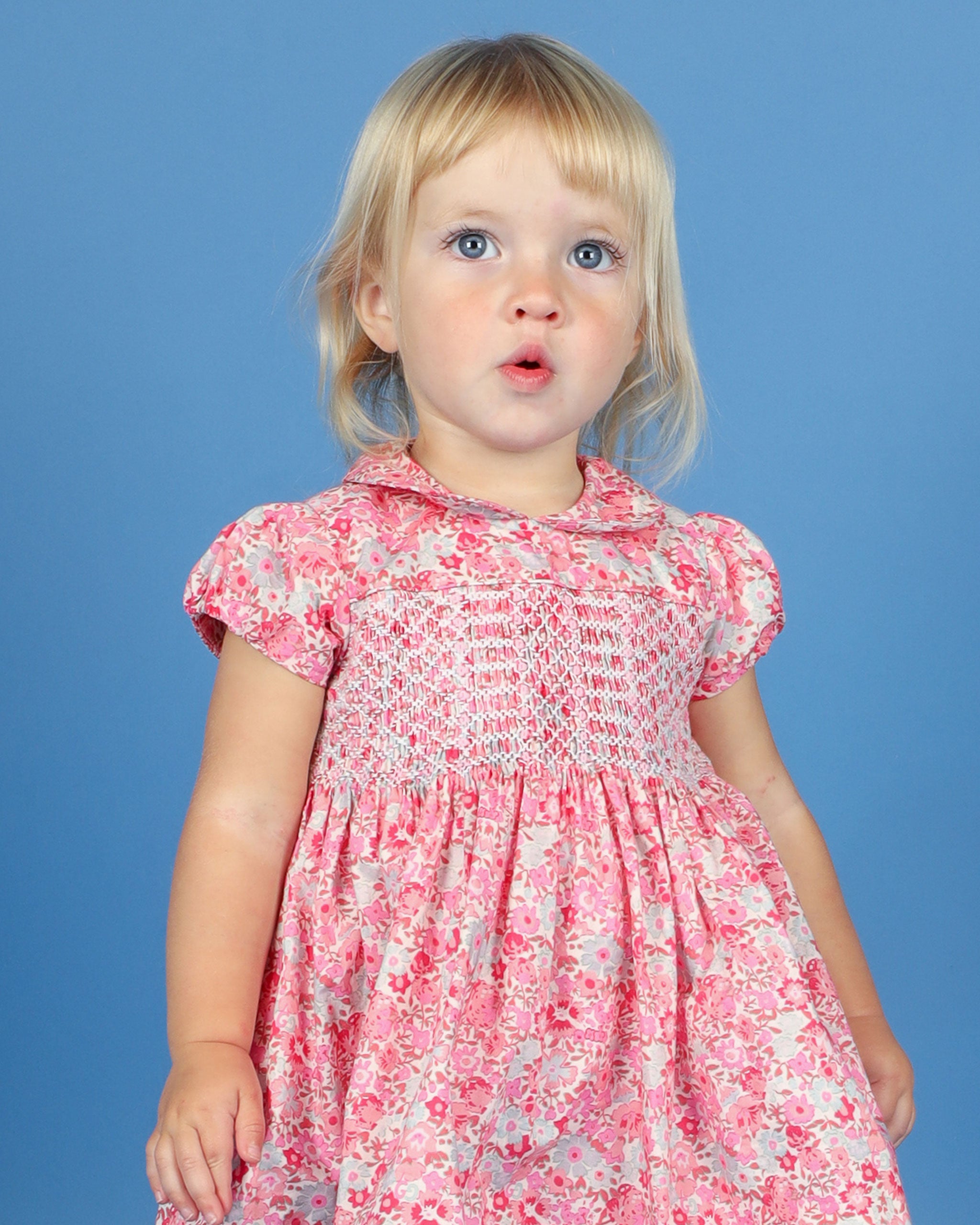 toddler in smock dress, pink, floral