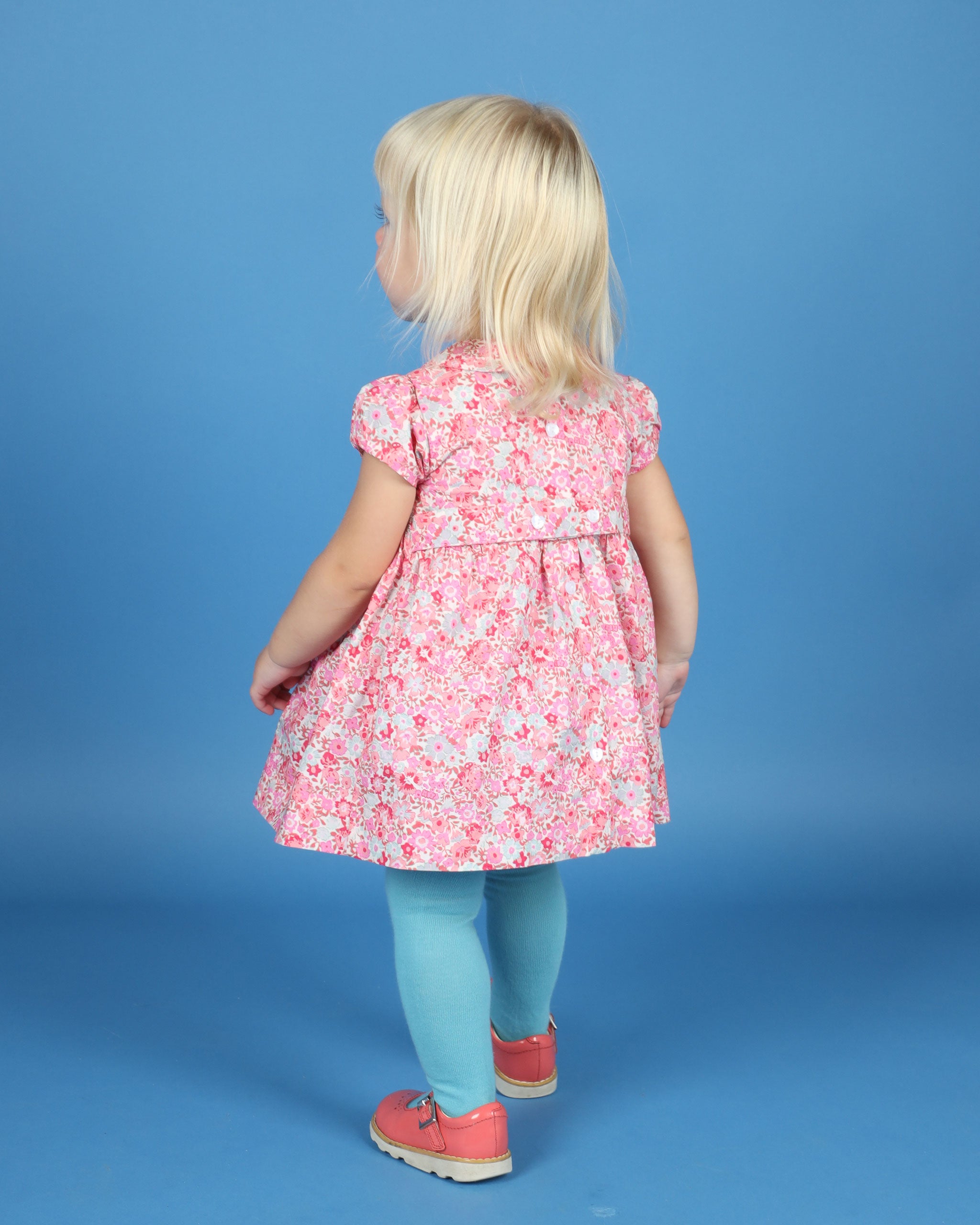 baby in pink dress, back view