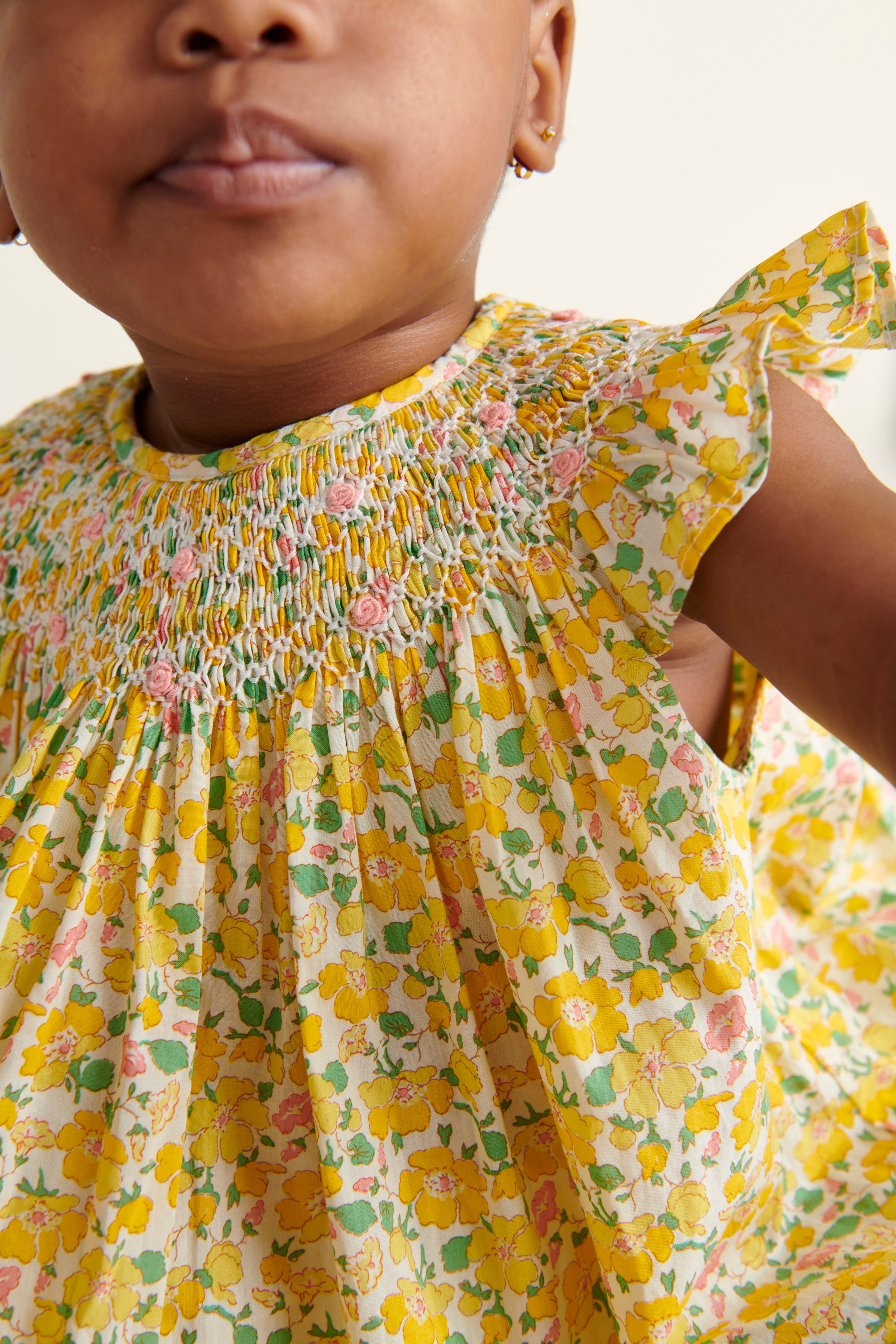 Toddler in hand-smoked Liberty dress, closeup