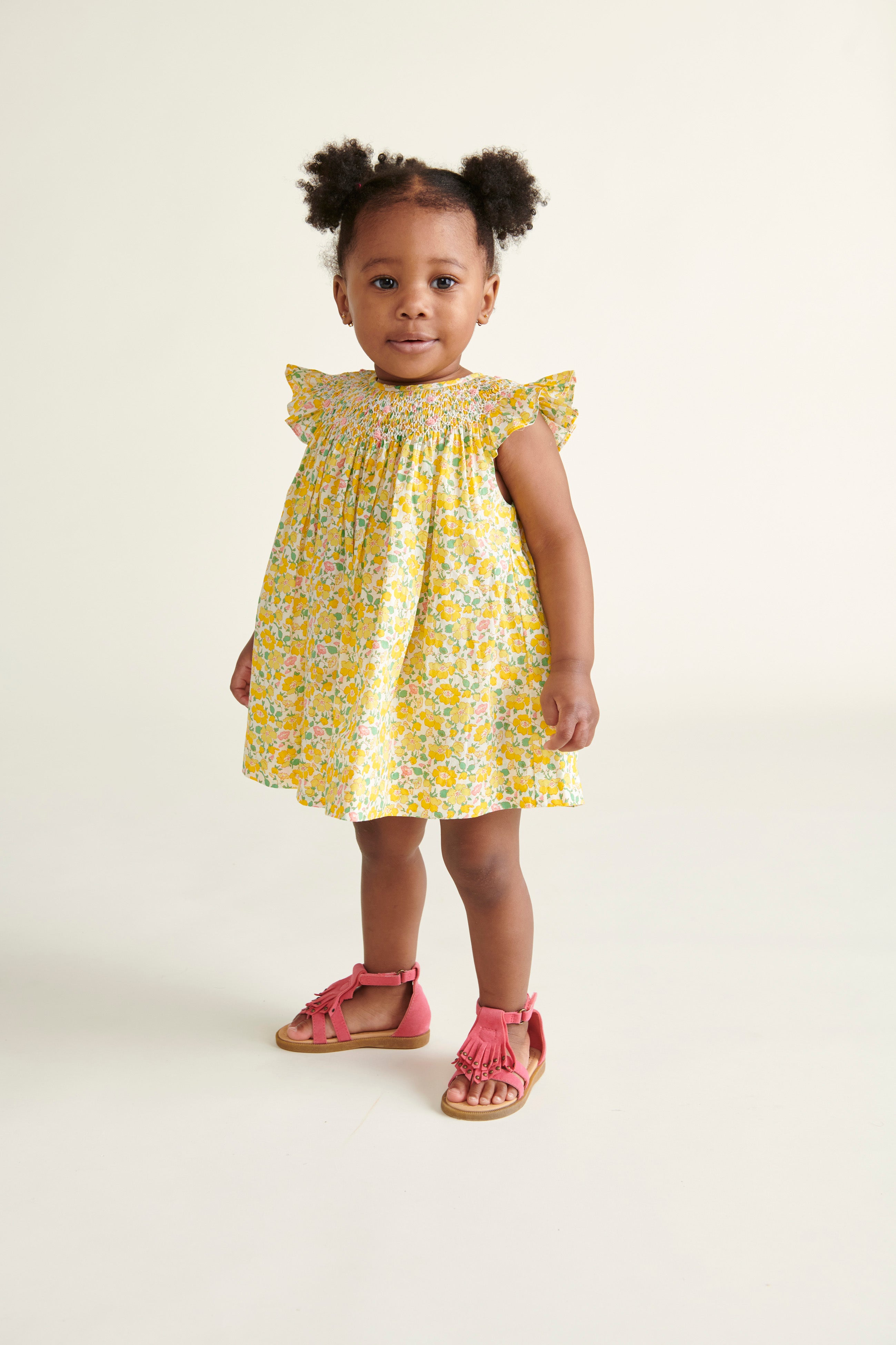 toddler girl in Liberty print yellow smocked dress