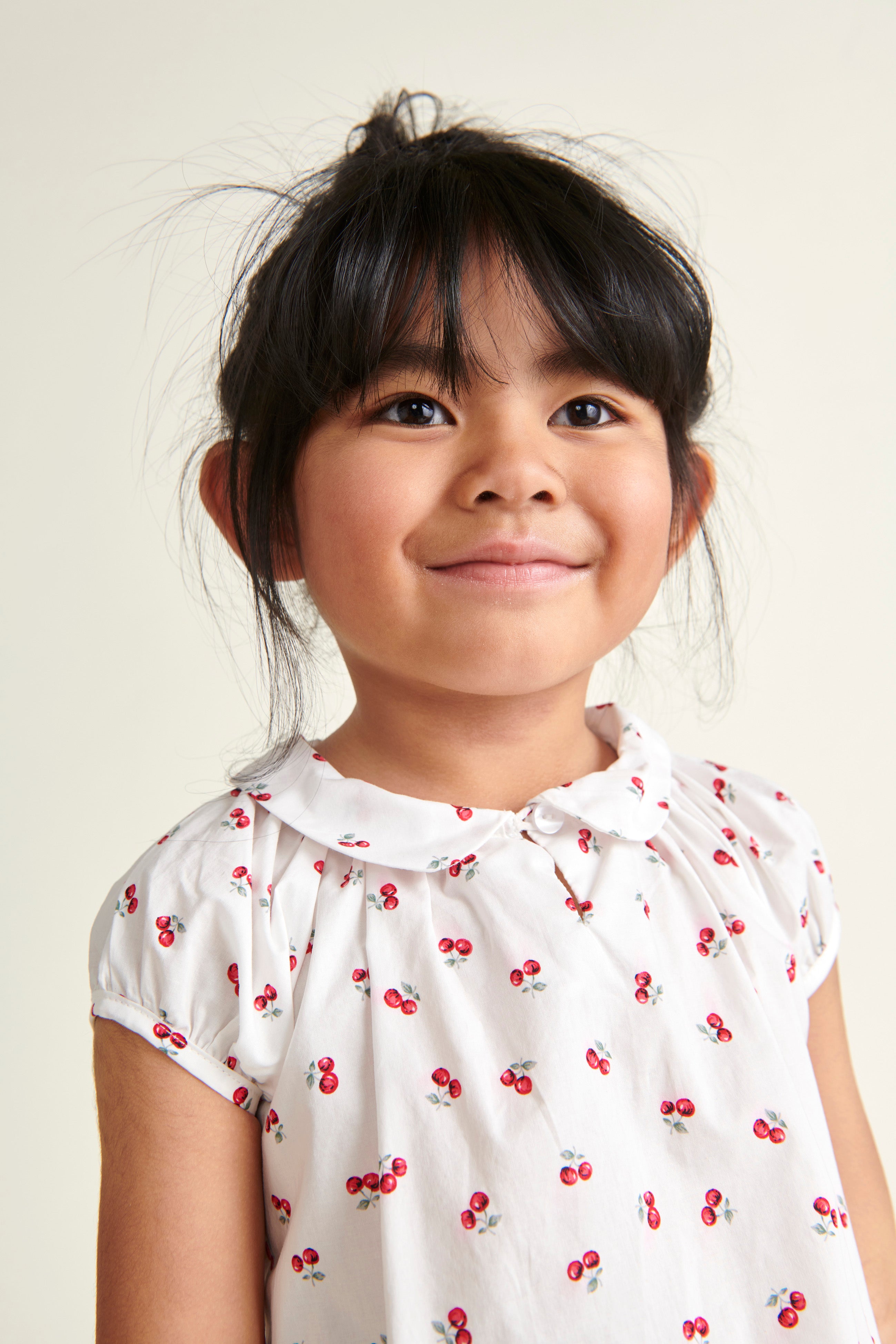 girl in cherry print blouse, white with red cherry