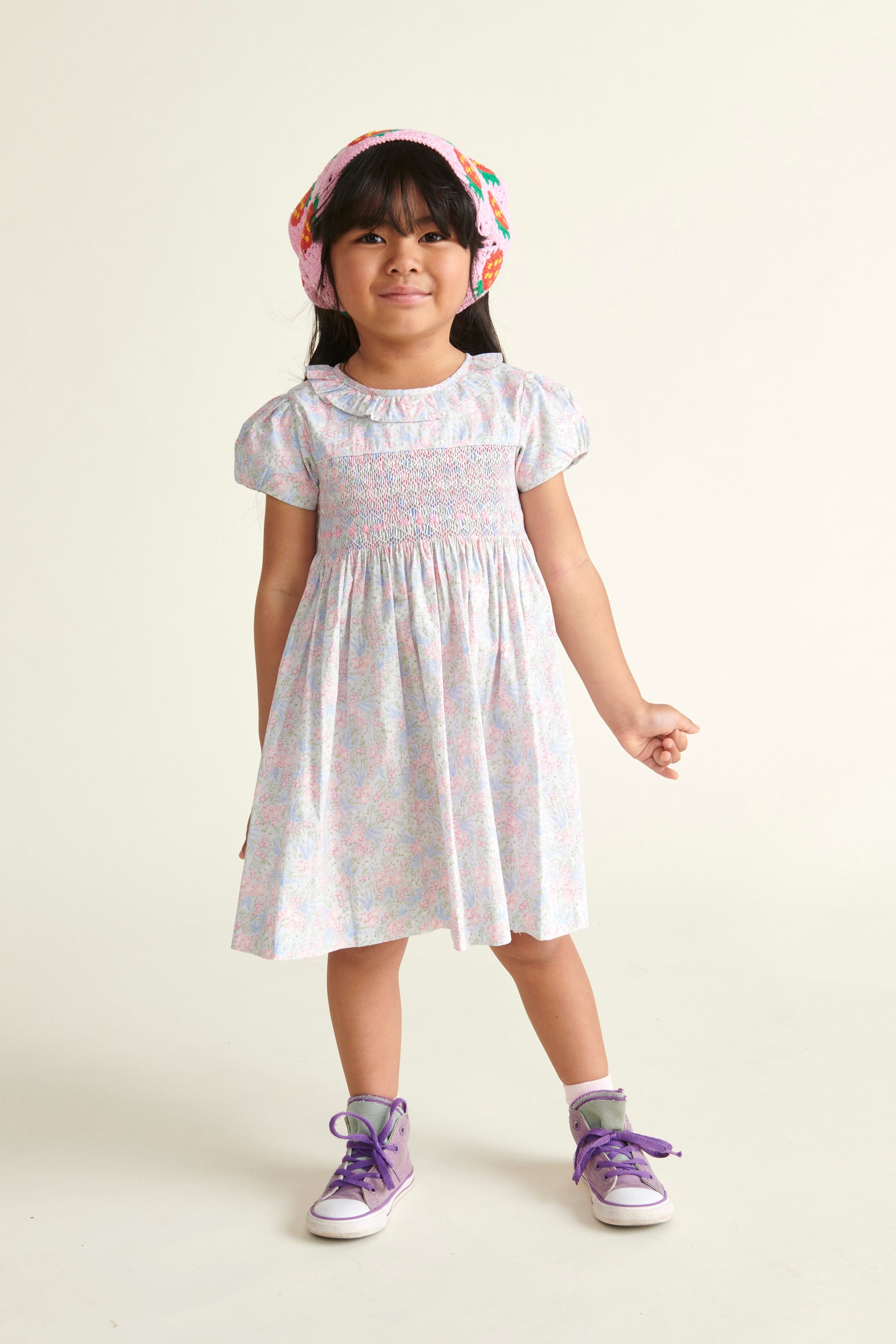 girl in pastel colour dress with smocking