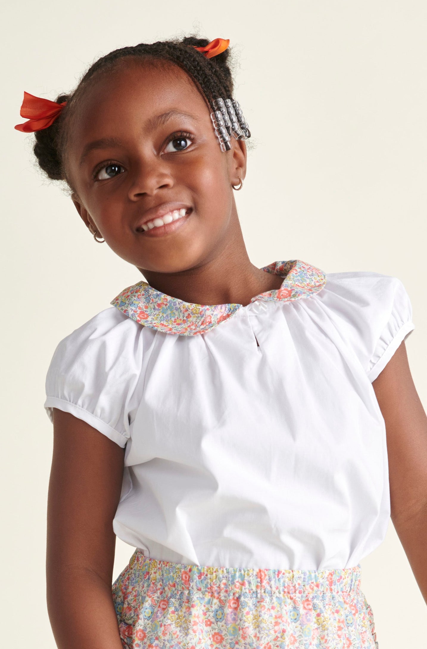 girl in white blouse with Liberty print collar