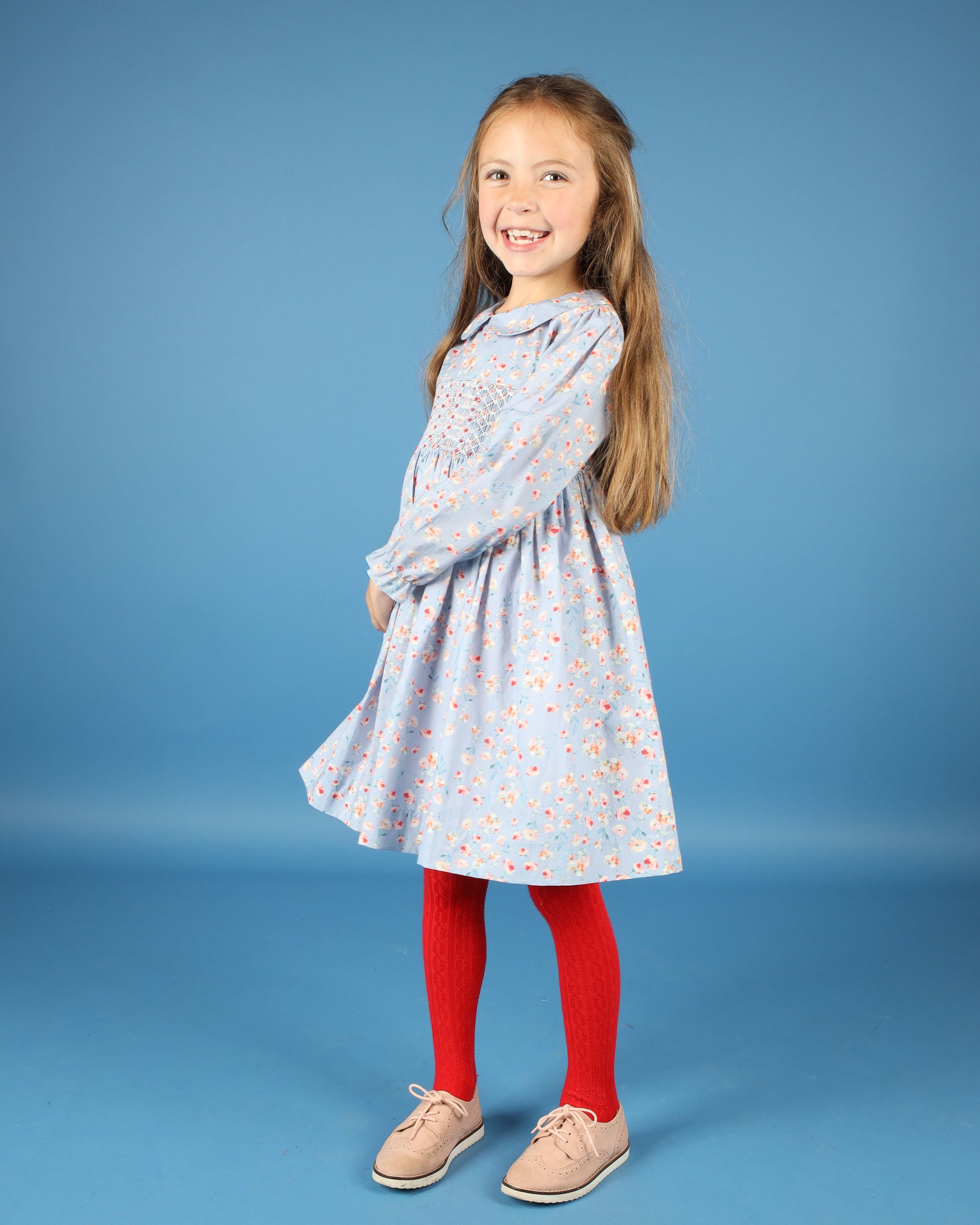 girl in light blue floral smocked dress