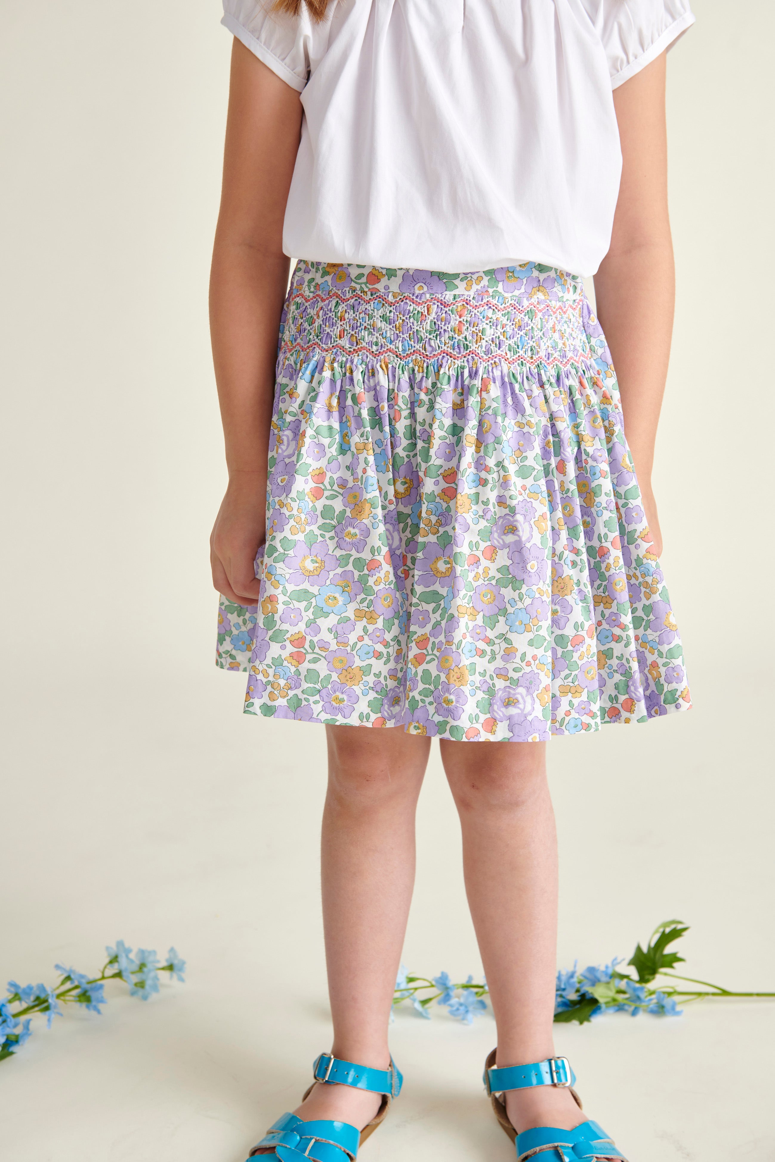 closeup of girl wearing purple smocked skirt