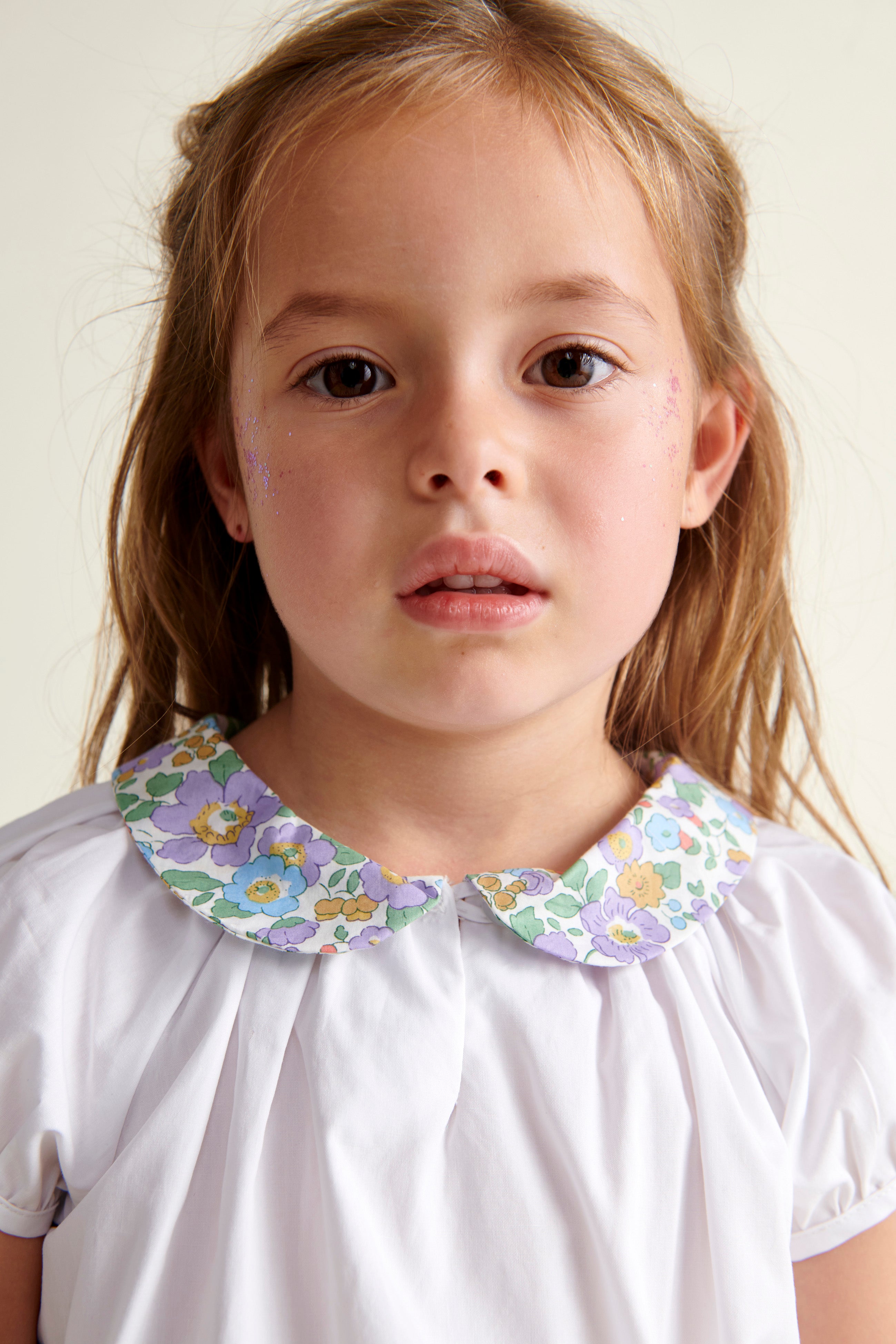 girl in blouse with floral collar