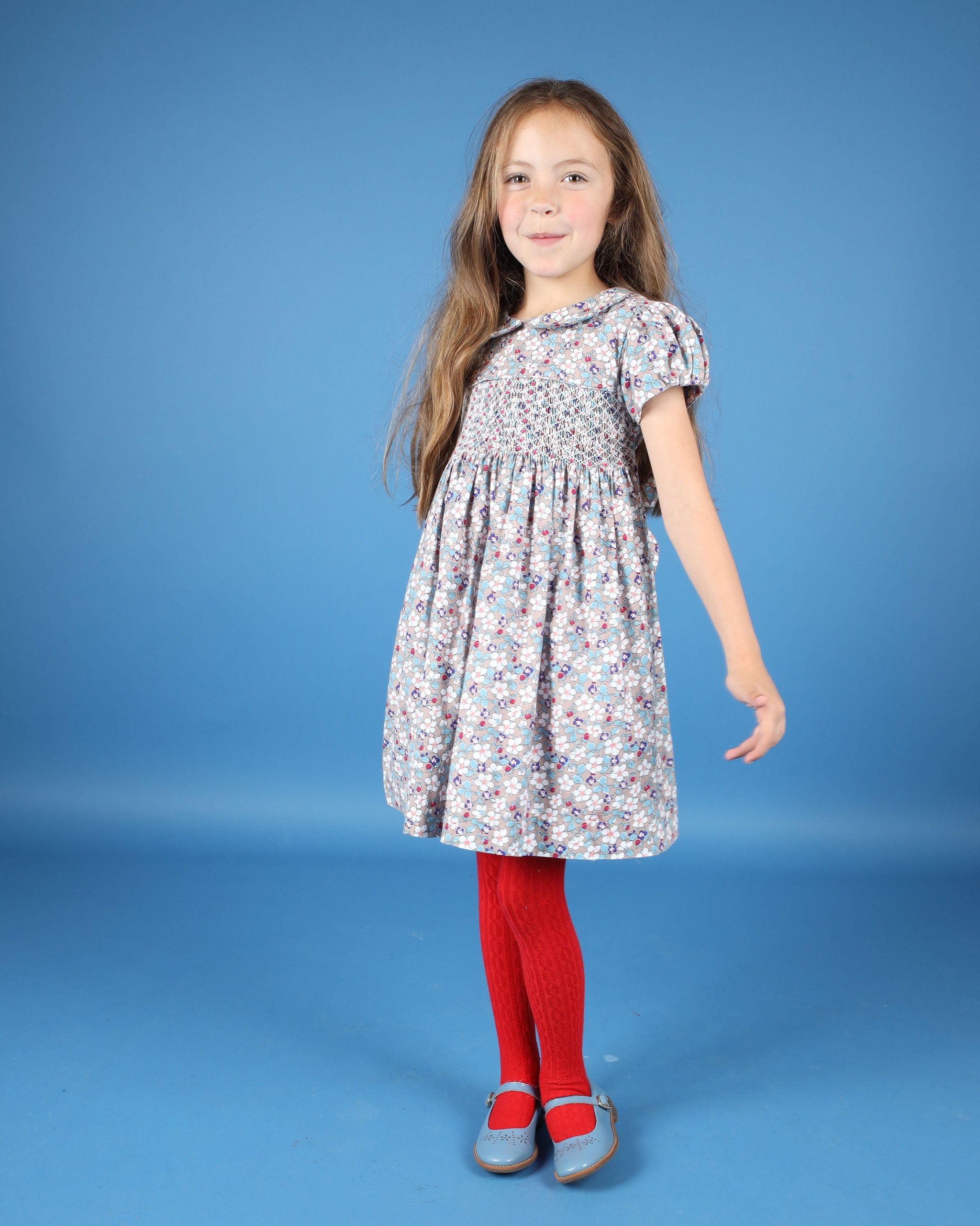 girl in floral hand-smocked winter dress