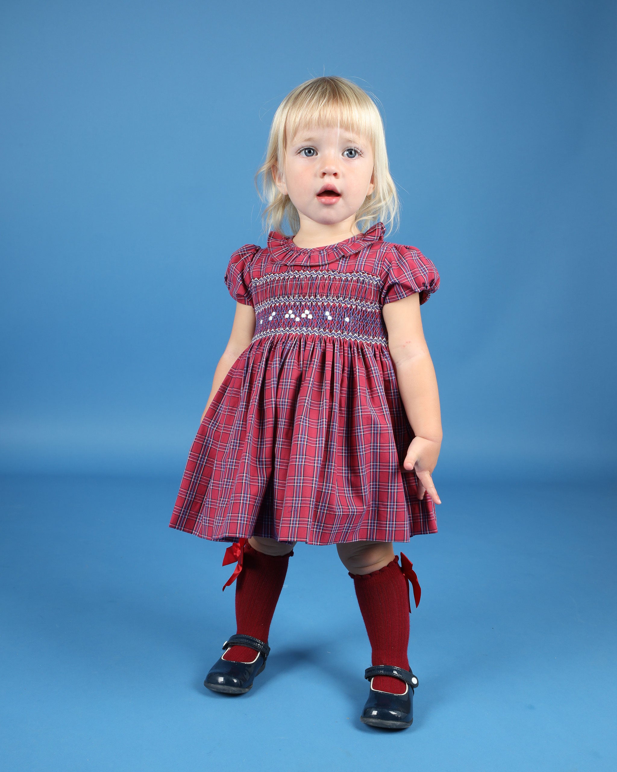 toddler in red and navy tartan dress