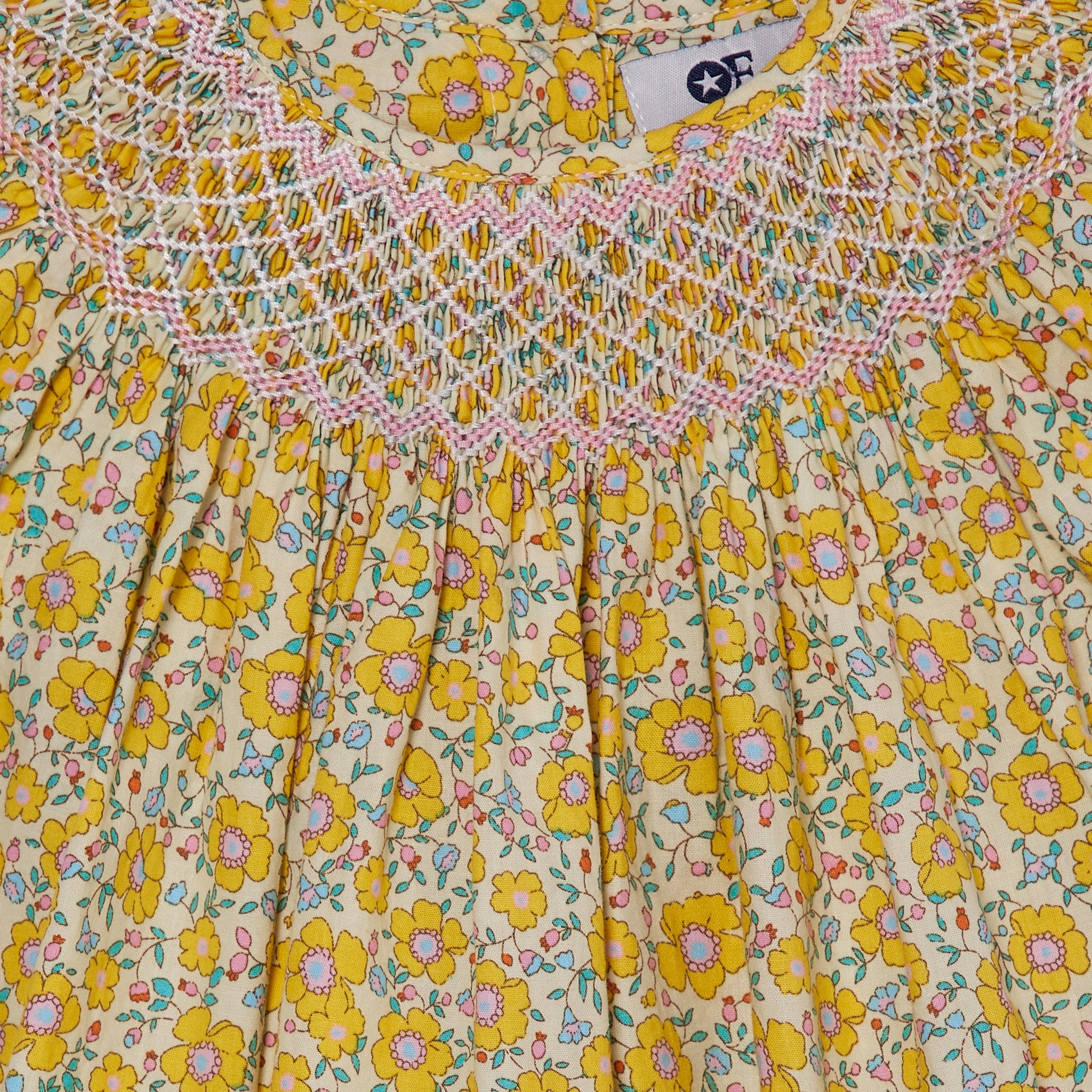 yellow smocked baby dress closeup